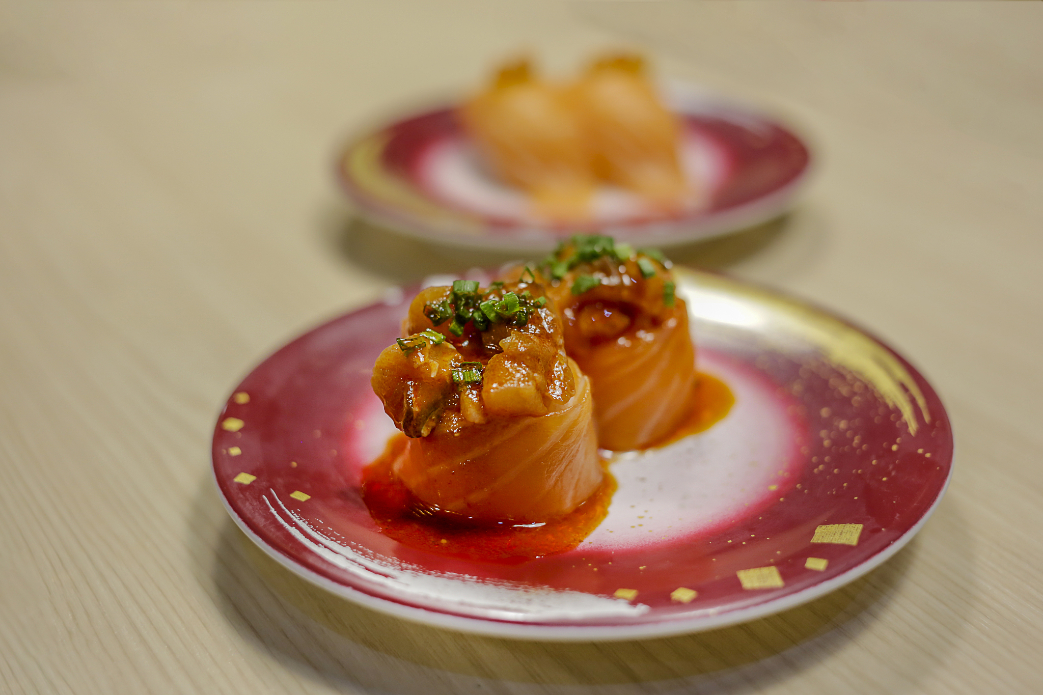 fresh red salmon slice with egg shrimp on a red   plate.