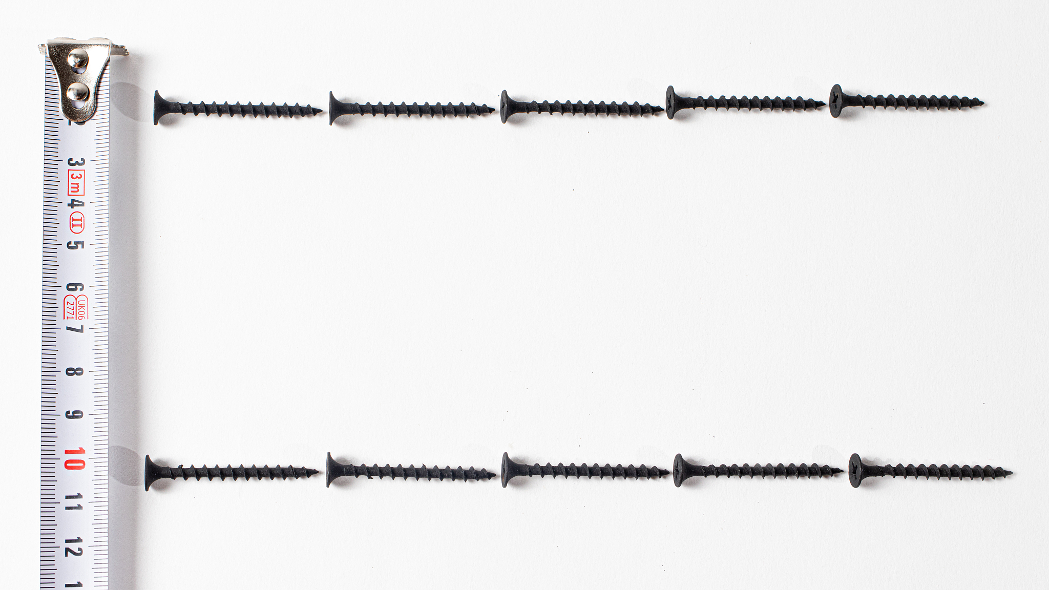 nails and measuring tape roulette on a white background. a banne