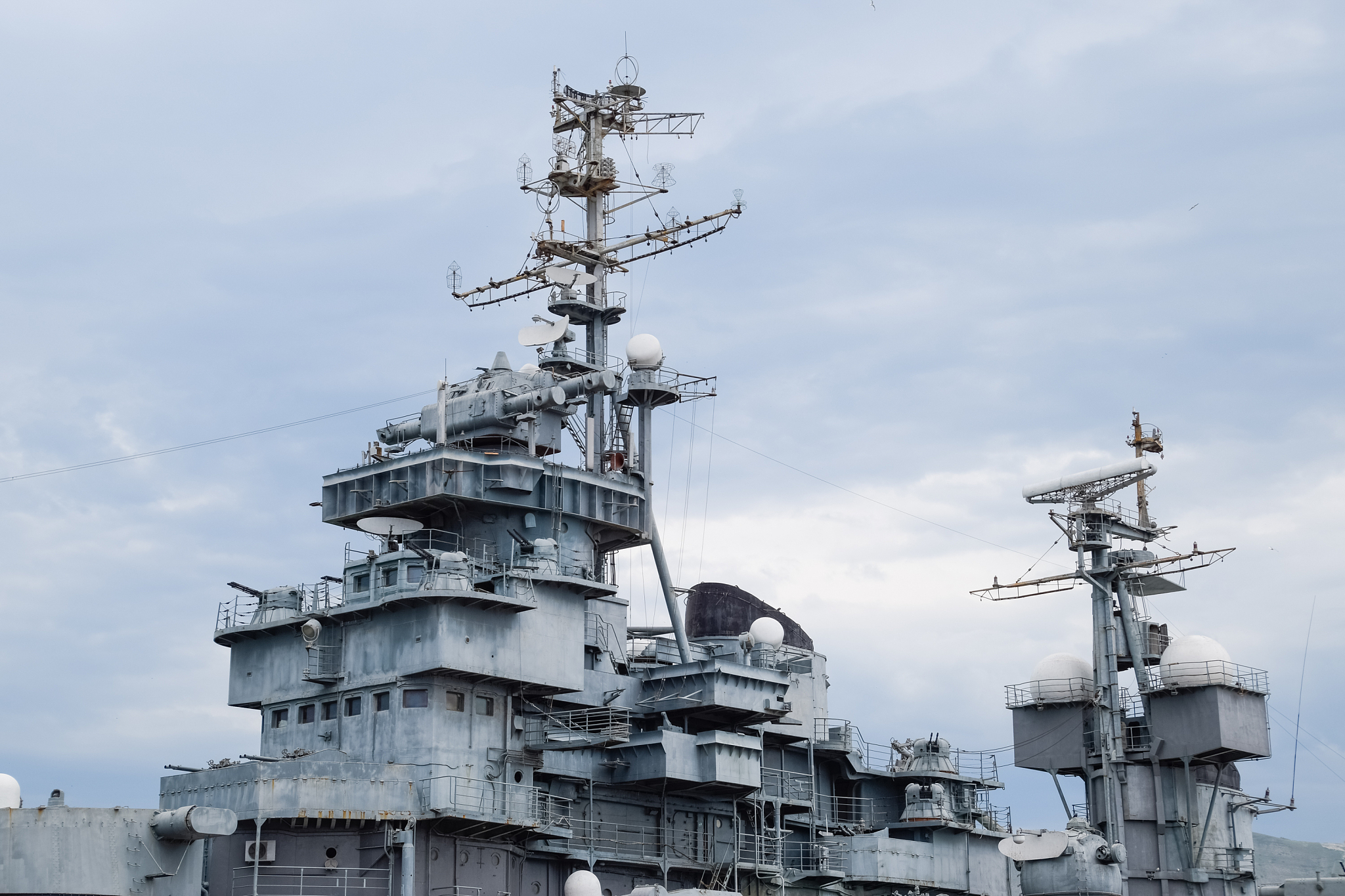 deck of a warship, weapons and communication antennas on the shi