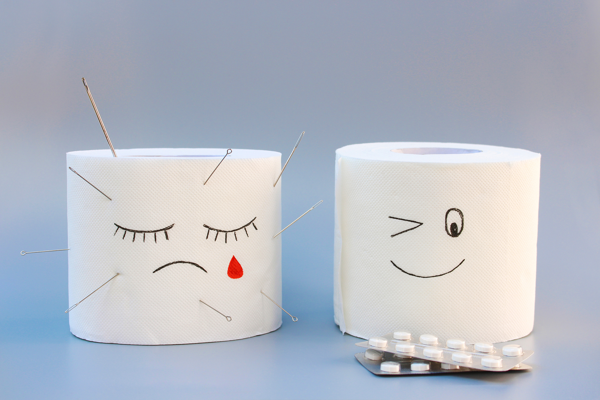 toilet paper and pills. concept of hemorrhoid treatment.