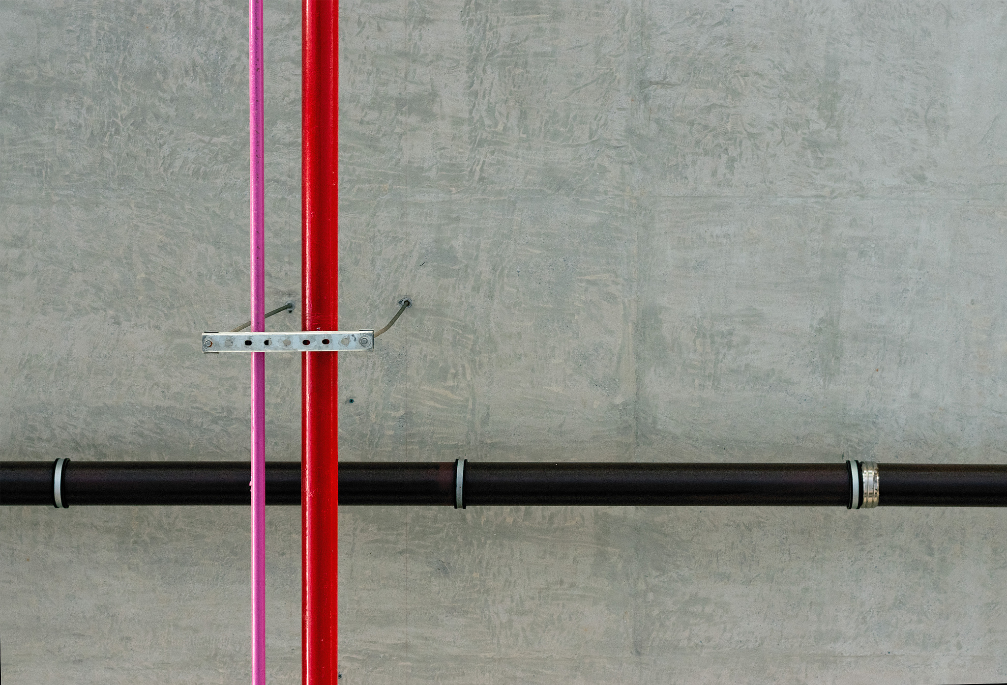 pipes attached to the ceiling of a subway train station, lots of