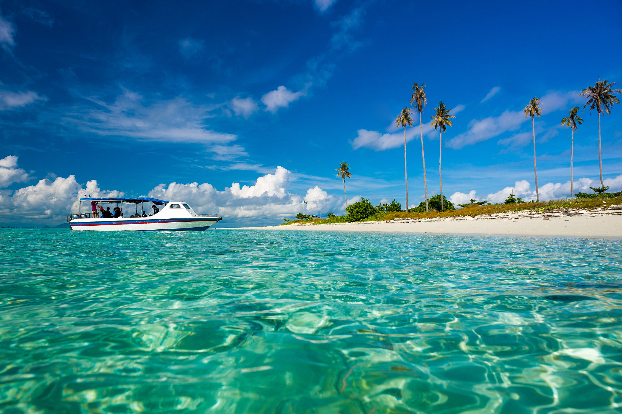 malaysia, sabah, boat moored on beach at island
