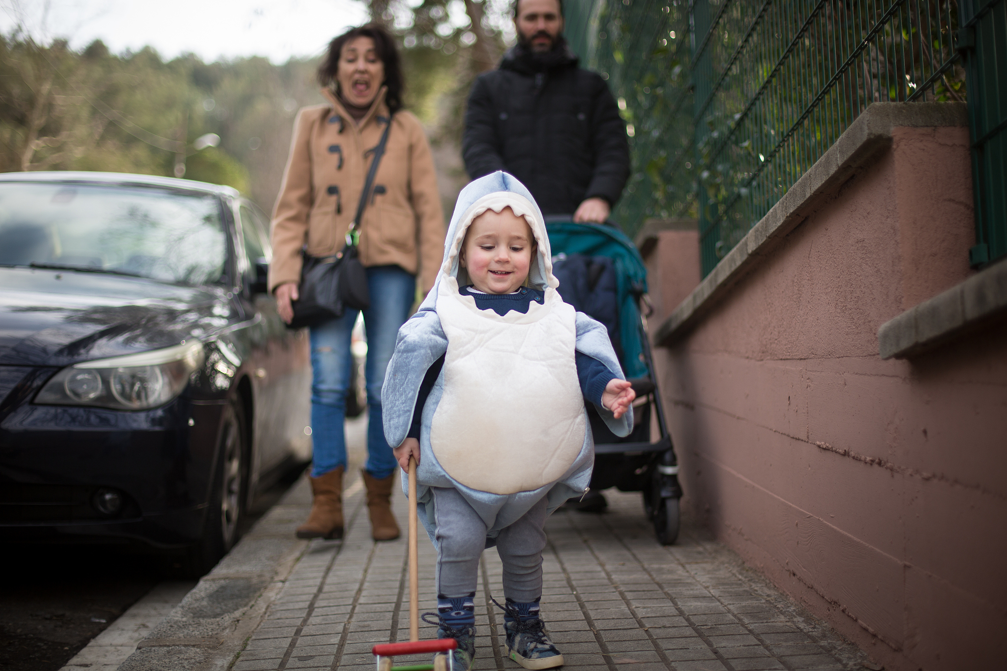 toddler dressed as a shark with grandma and dad