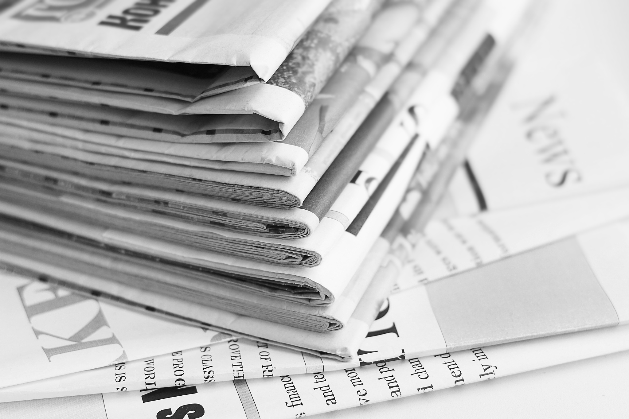 stack of newspapers and news pages