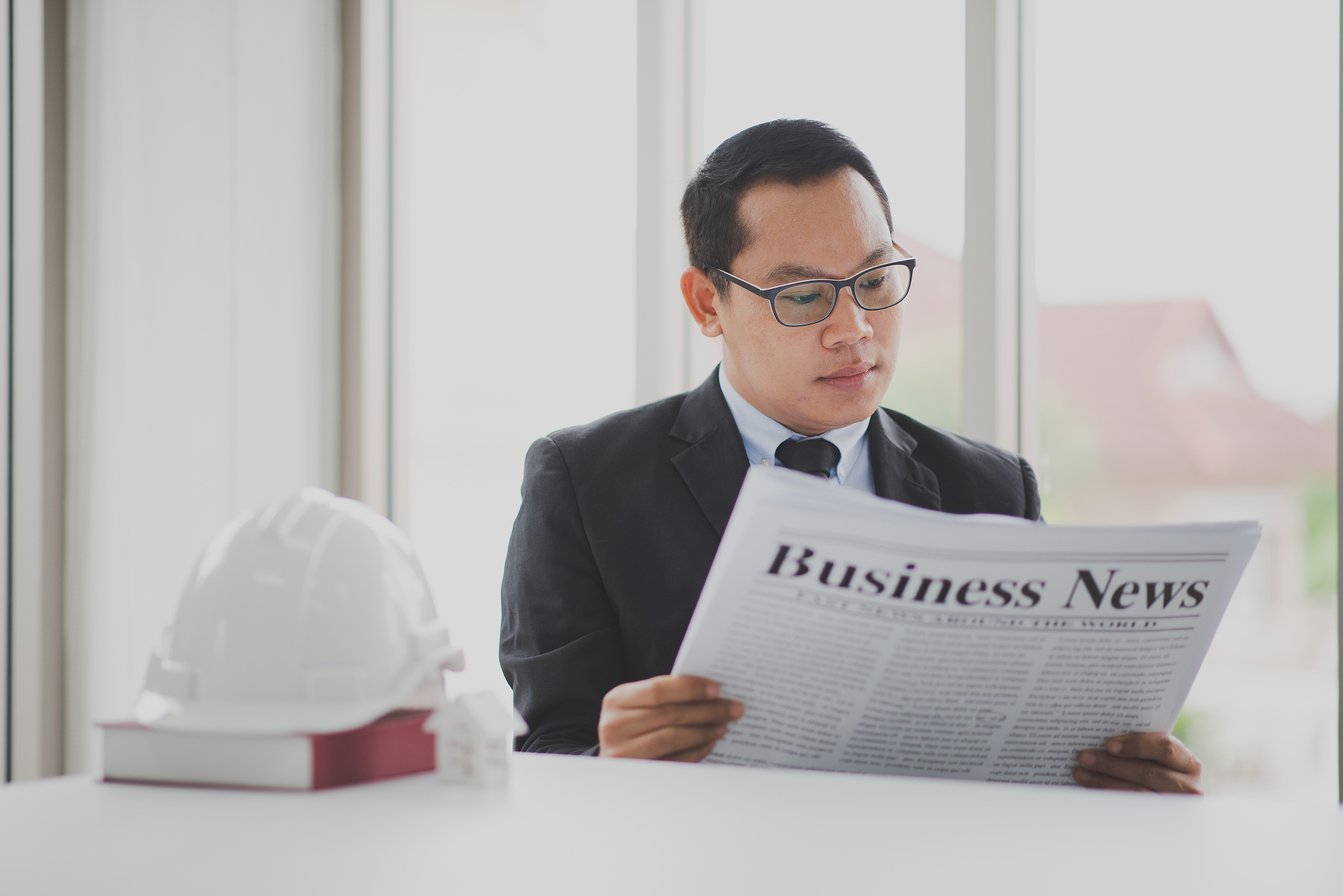 business man is reading business news paper in morning at the of