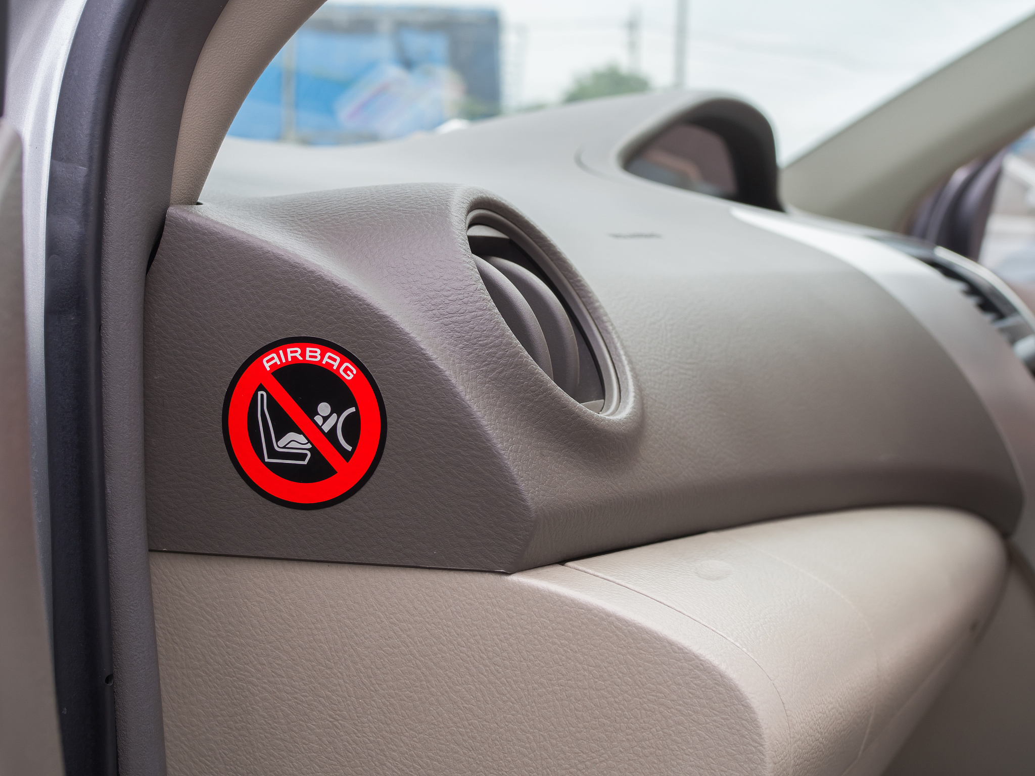 red caution sign for safety child air bag in car.