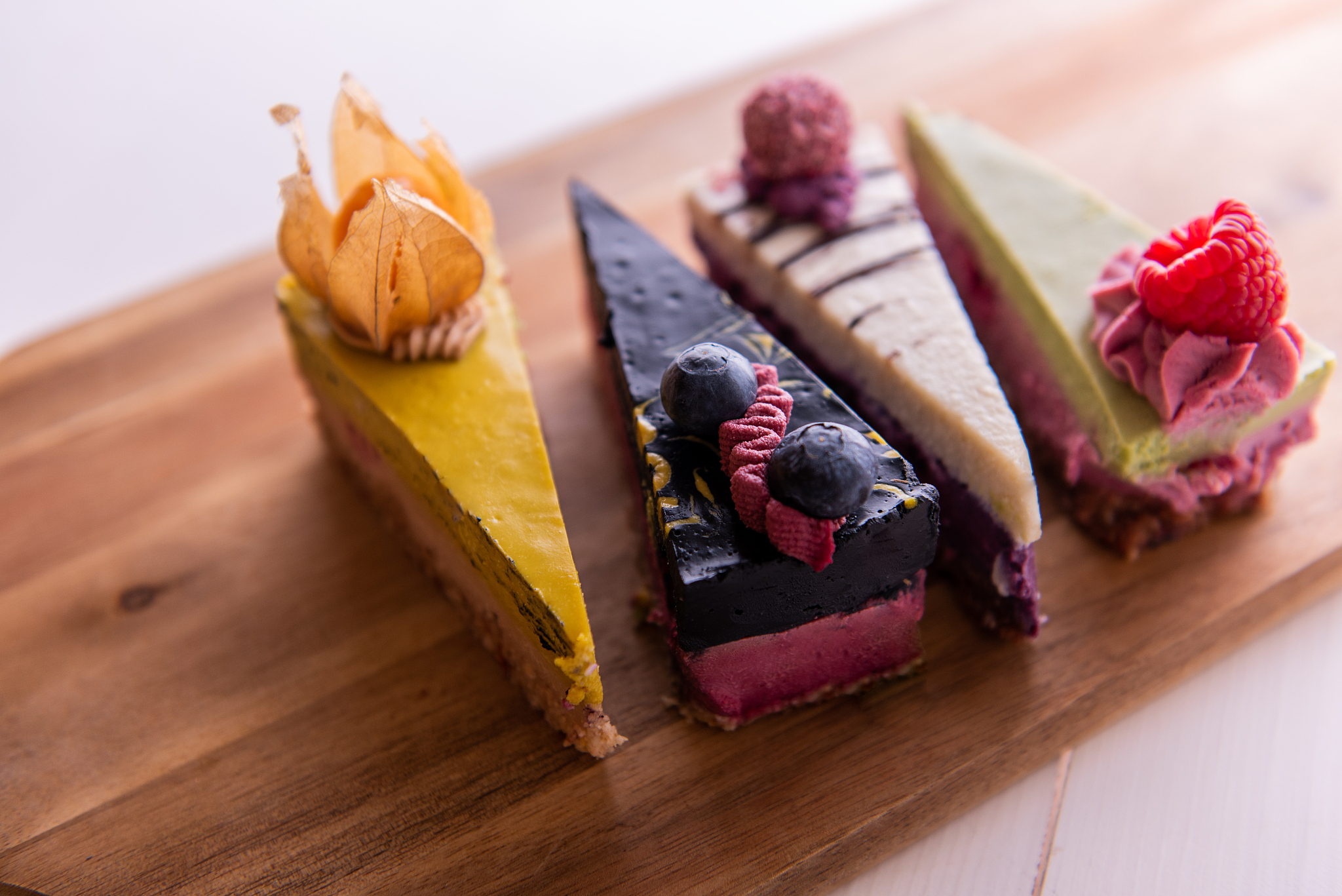 random selection of healthy vegan raw colorful fruit cakes