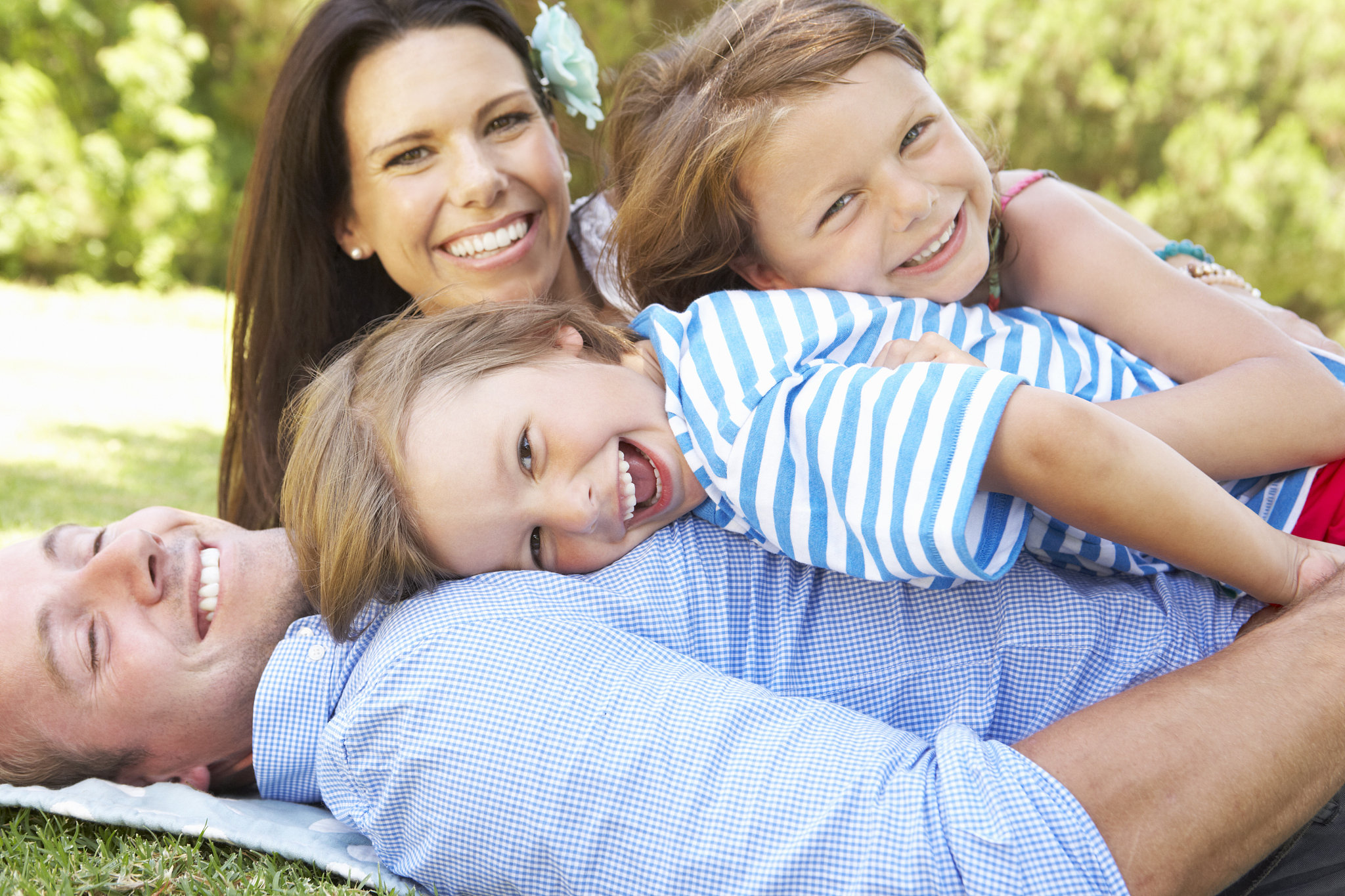 family relaxing in garden together