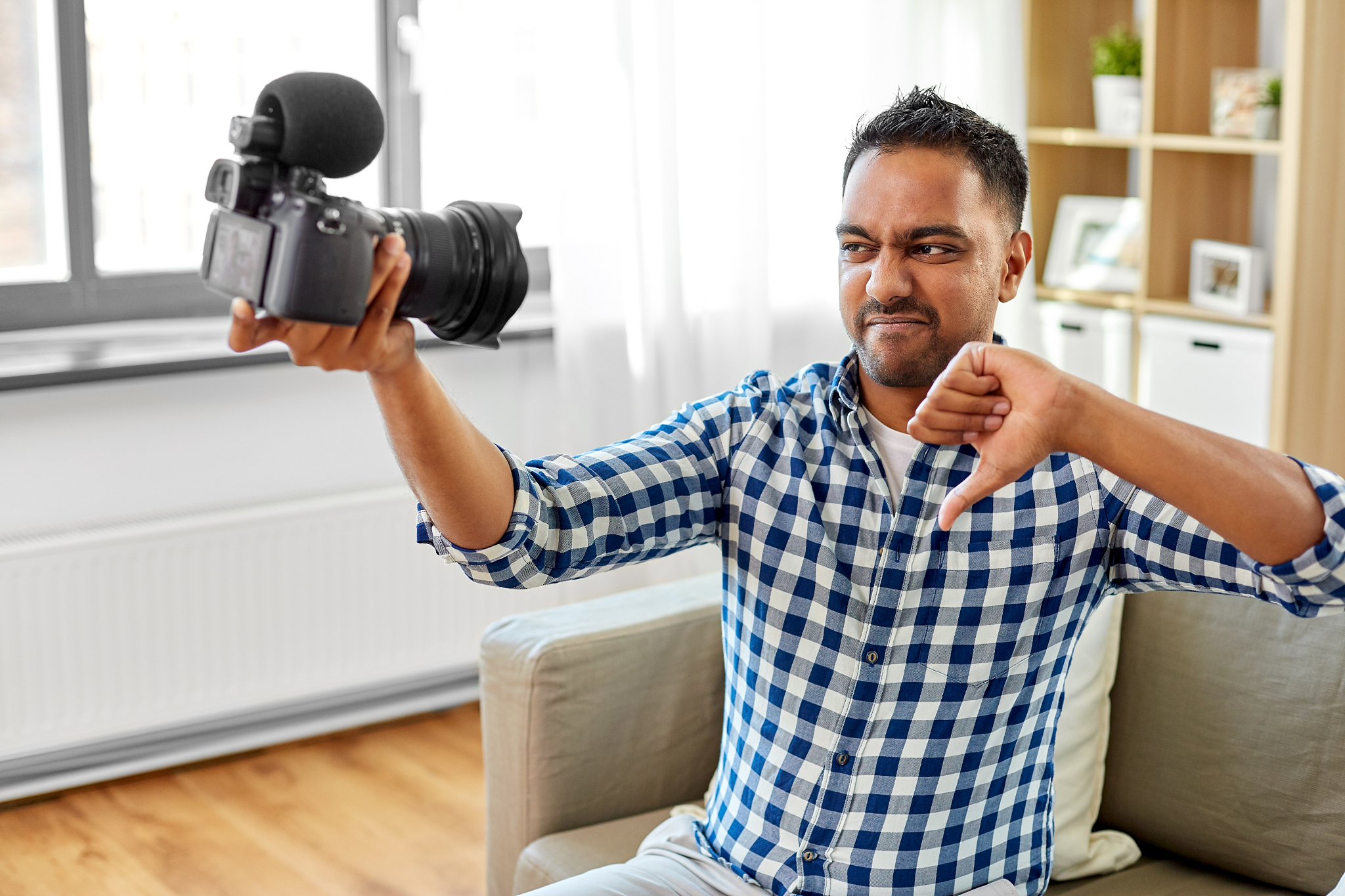 blogging, videoblog and people concept - displeased indian male 
