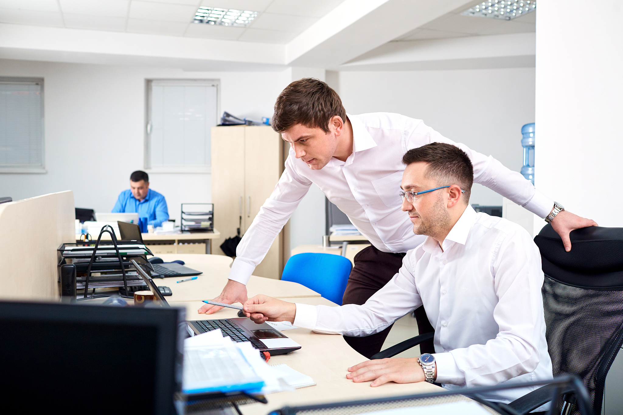 two businessman working in the office with documents stoloms com