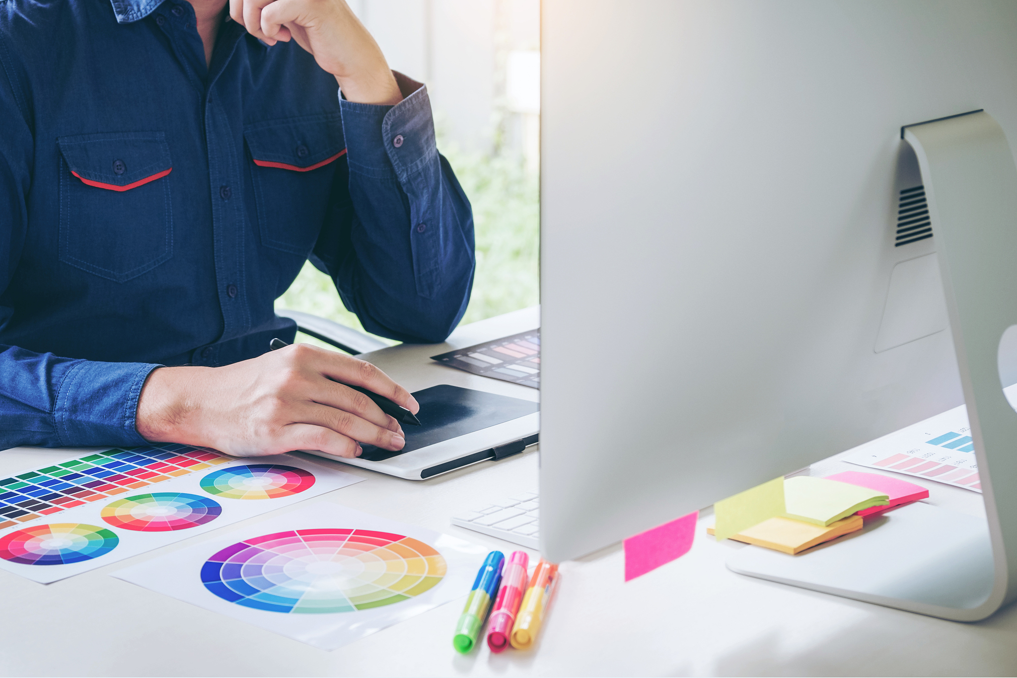 graphic designer drawing on graphics tablet at workplace
