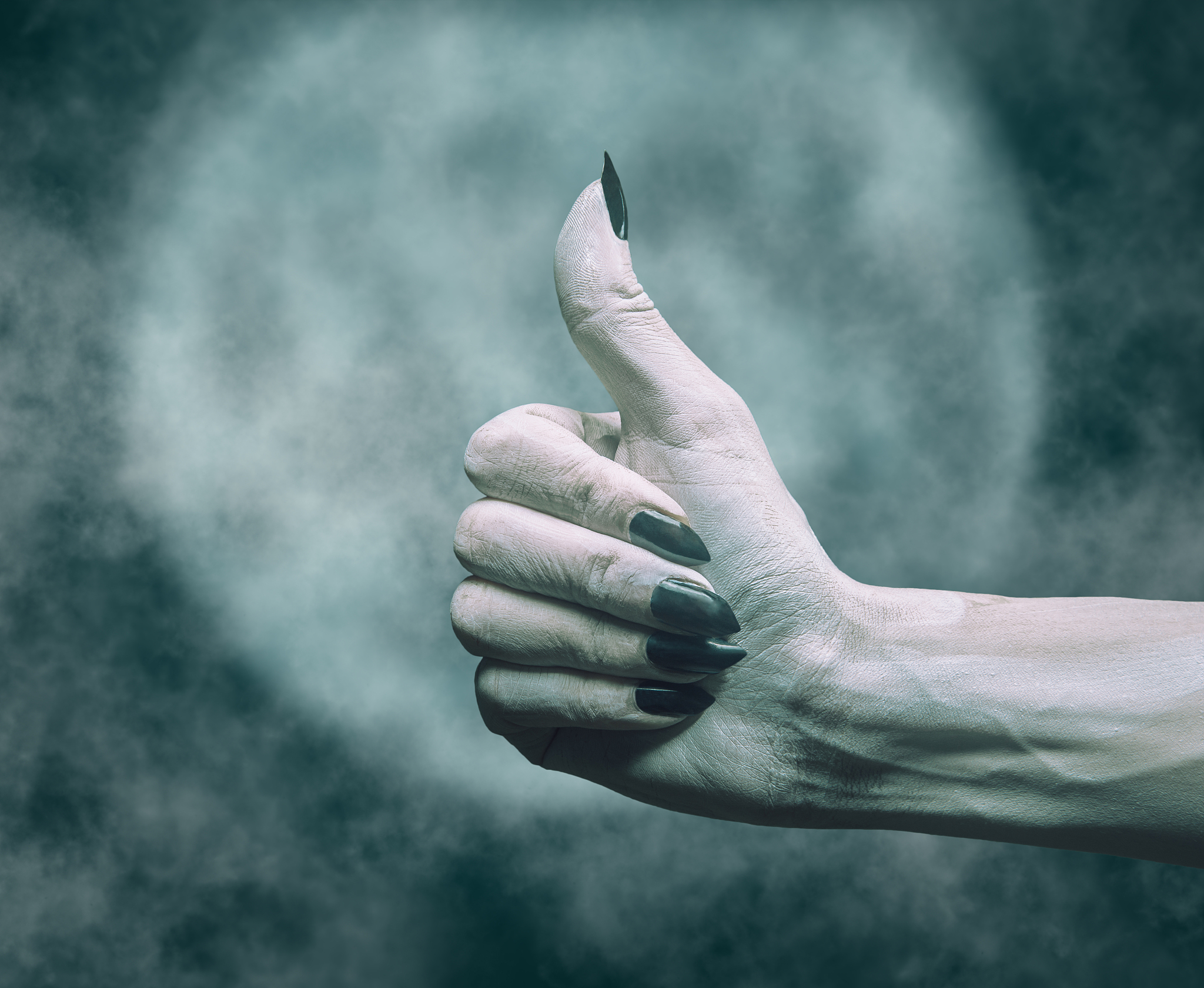dead hand with thumb up gesture in halloween night.