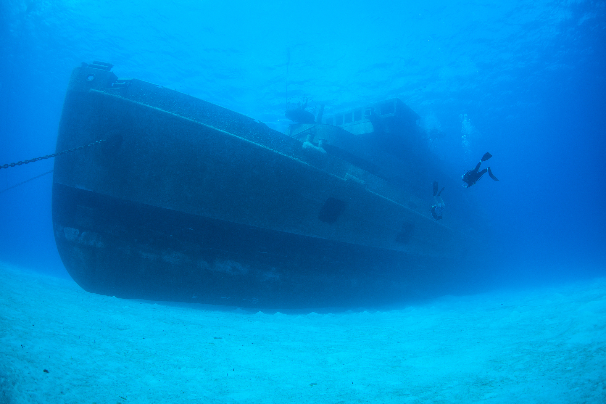huge shipwreck and scuba diver in grand cayman