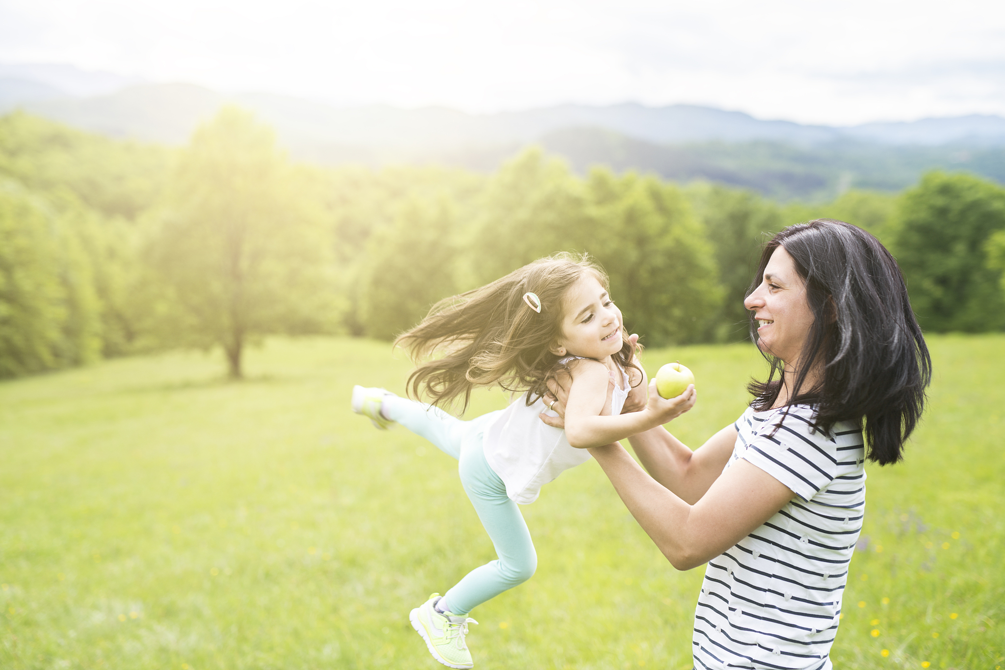 woman and his little daughter having fun outside.