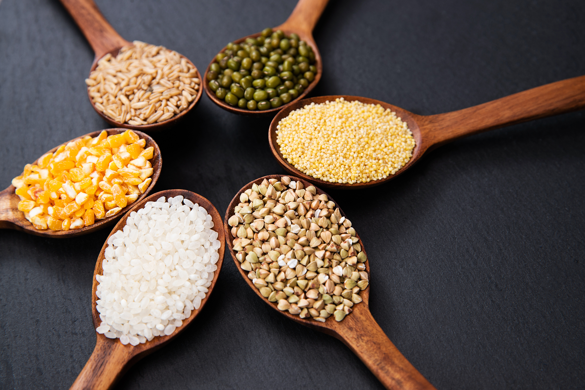 wooden spoon is filled with grain