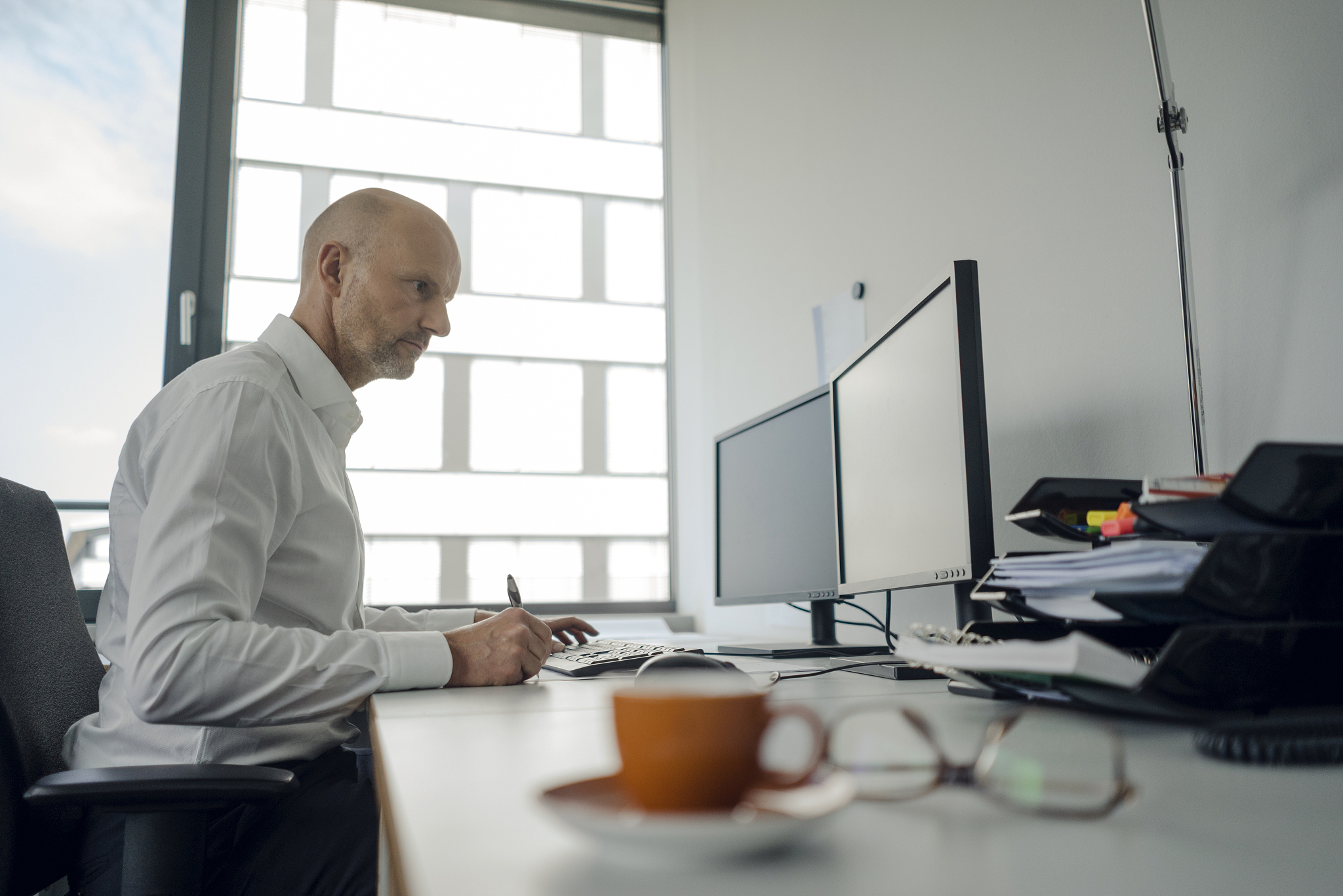 businessman working on his computer, taking notes
