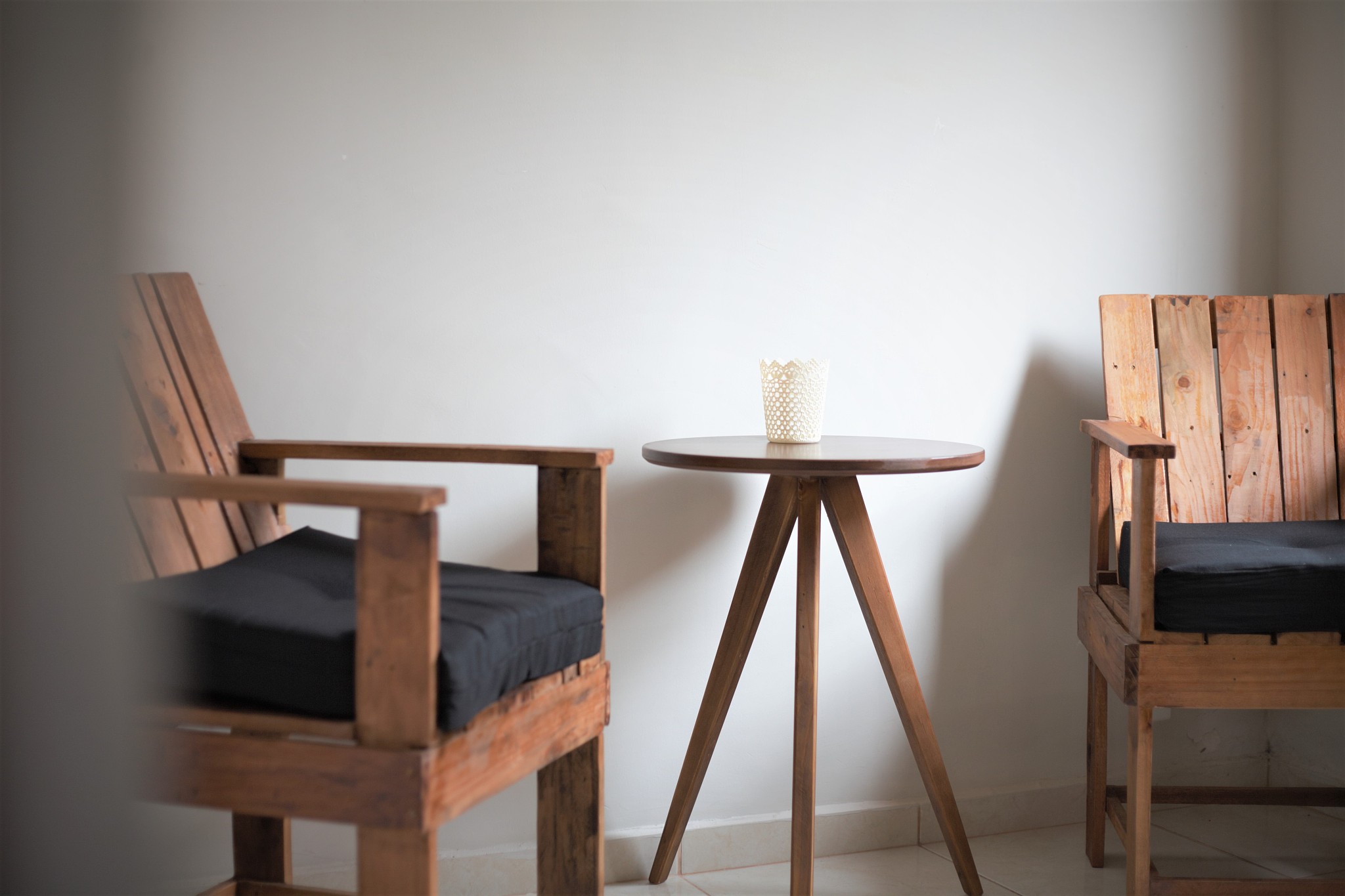 wooden chair made from recycled pallet wood with black cushion