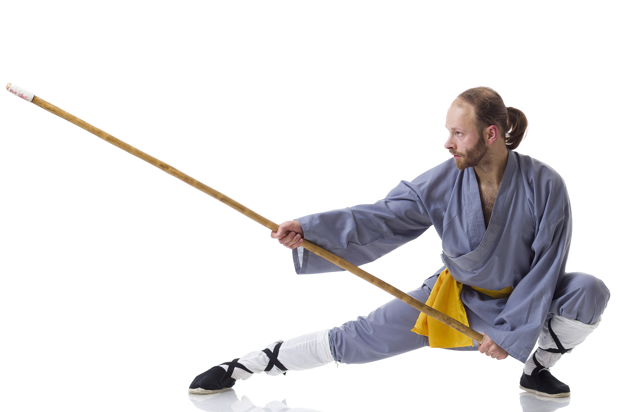 kung fu fighting position with wushu cudgel isolated on white