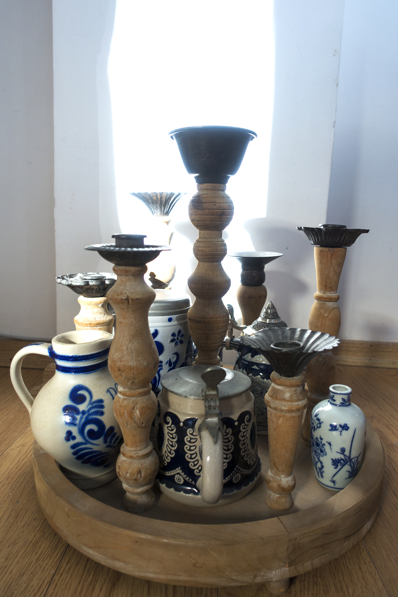 wooden candlesticks with blue and white ceramics.