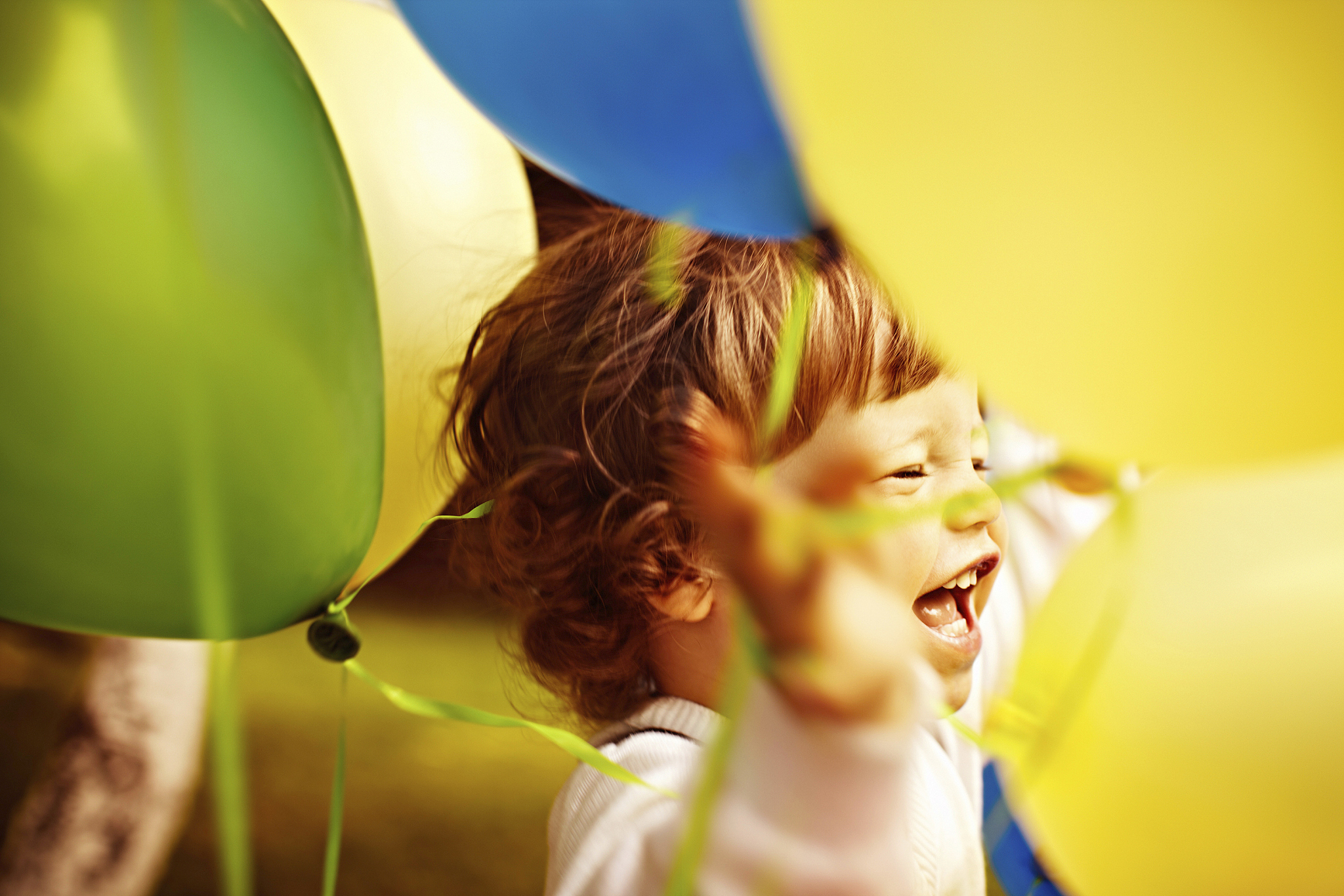 little boy between colorful balloons.