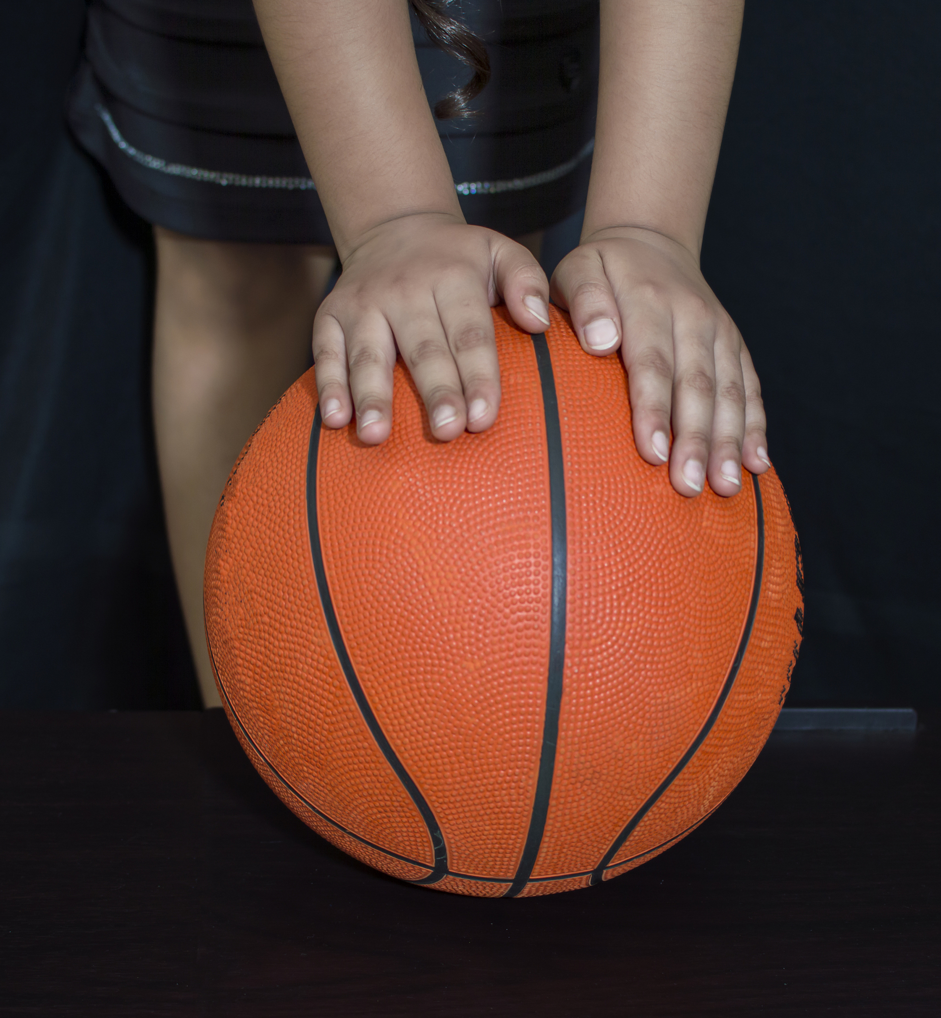 two hands on the basketball