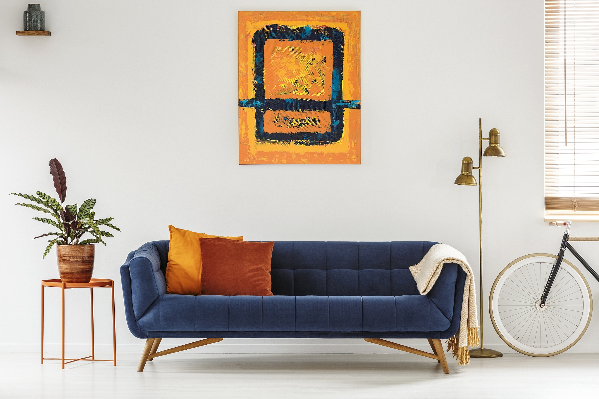 white living room interior with royal blue lounge, modern art pa