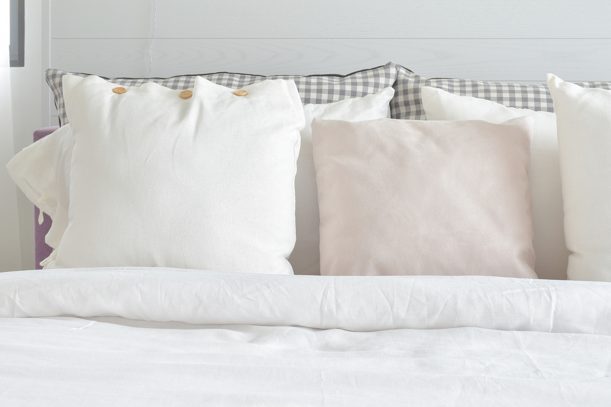 off white pillows setting on bed with english country style bedd