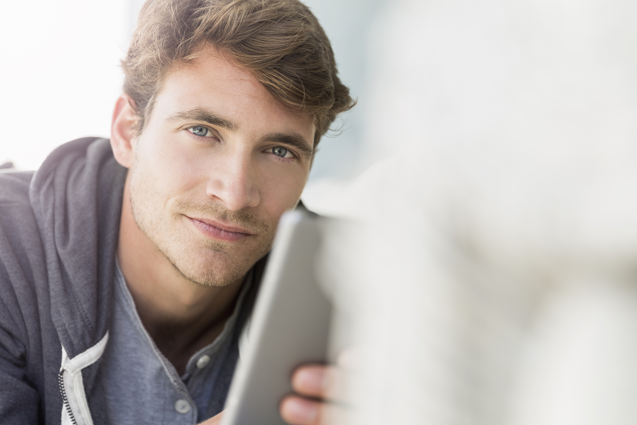 portrait of confident man lying on sofa