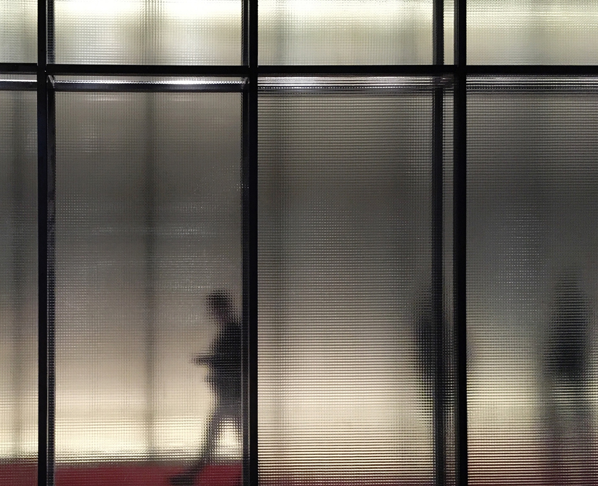 people seen through translucent glass