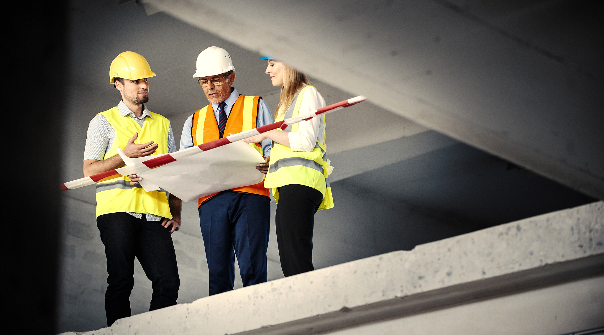 consulting about blueprints on a reconstruction site