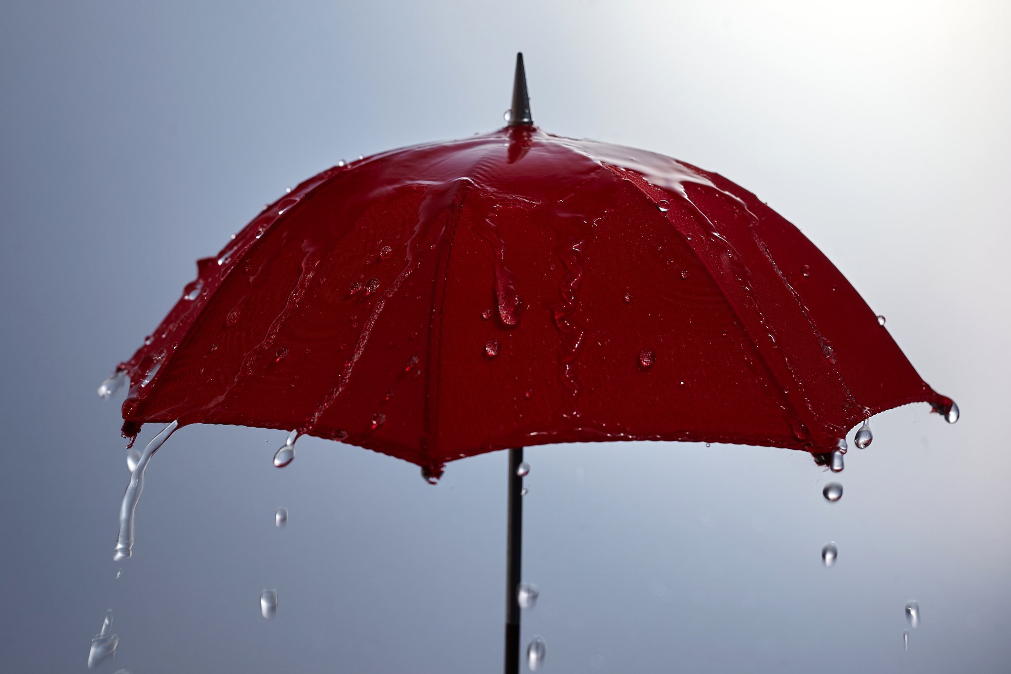 rain drops falling from red umbrella. bad weather concept.