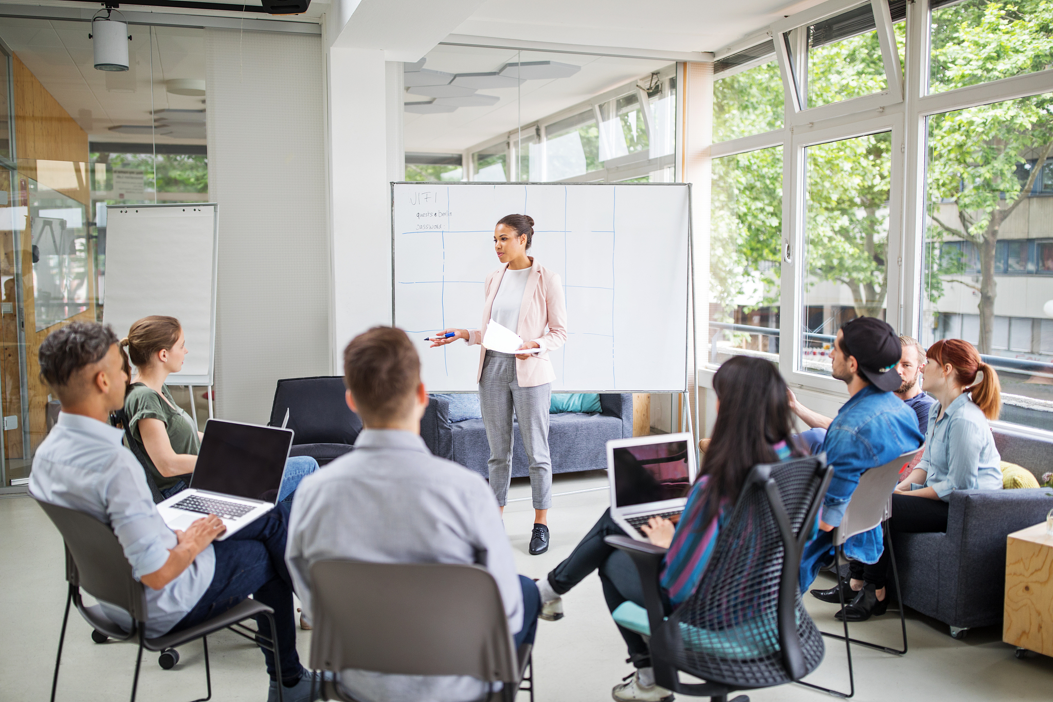 businesswoman giving presentation to team