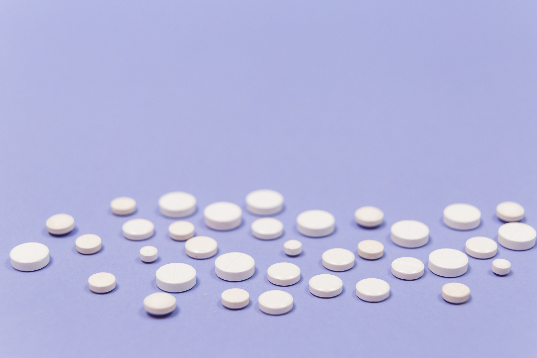 white pill on a purple background with copy space. antibiotics d
