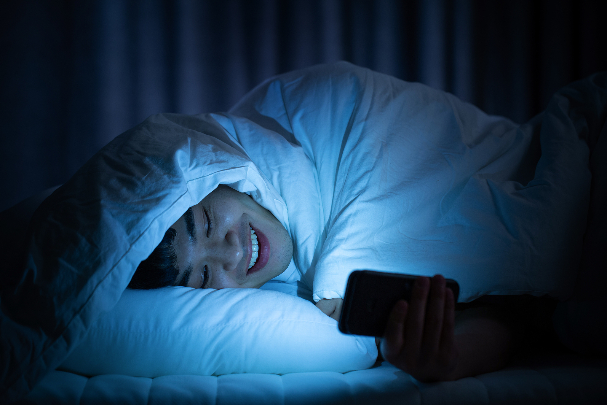 male, room, bedroom, smartphone, surfing the internet, smile