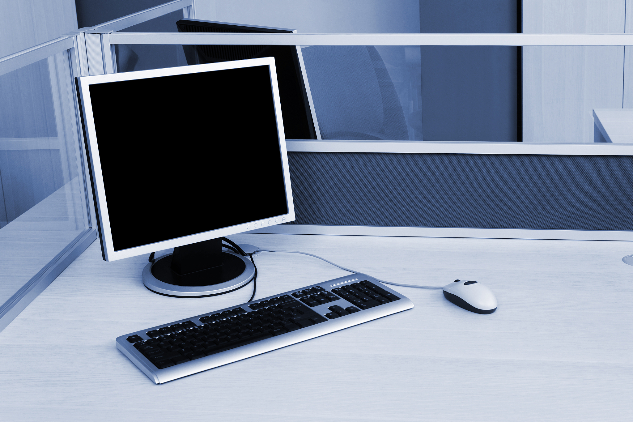 computers behind the glass in modern office