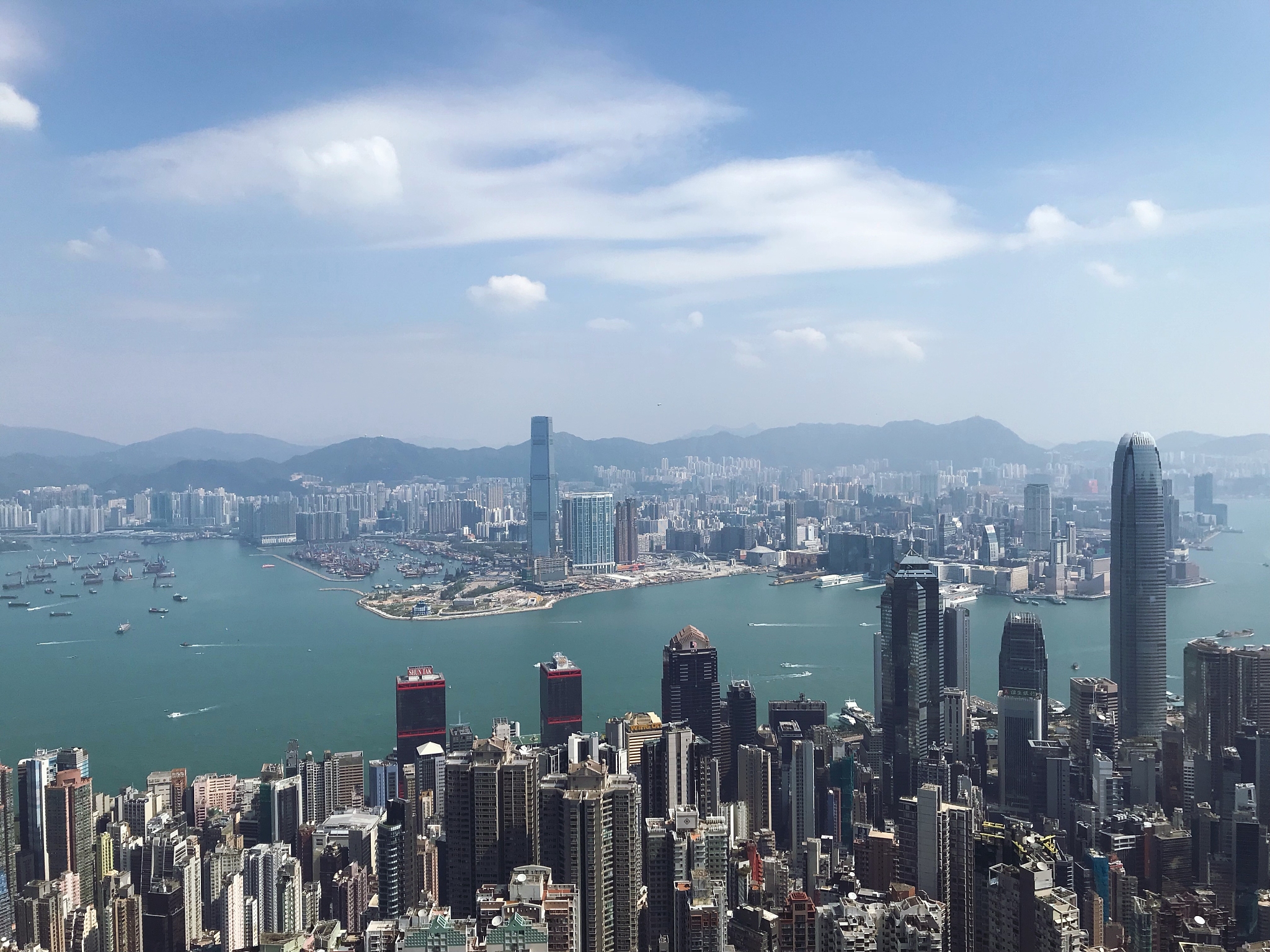 aerial view of city buildings against cloudy sky