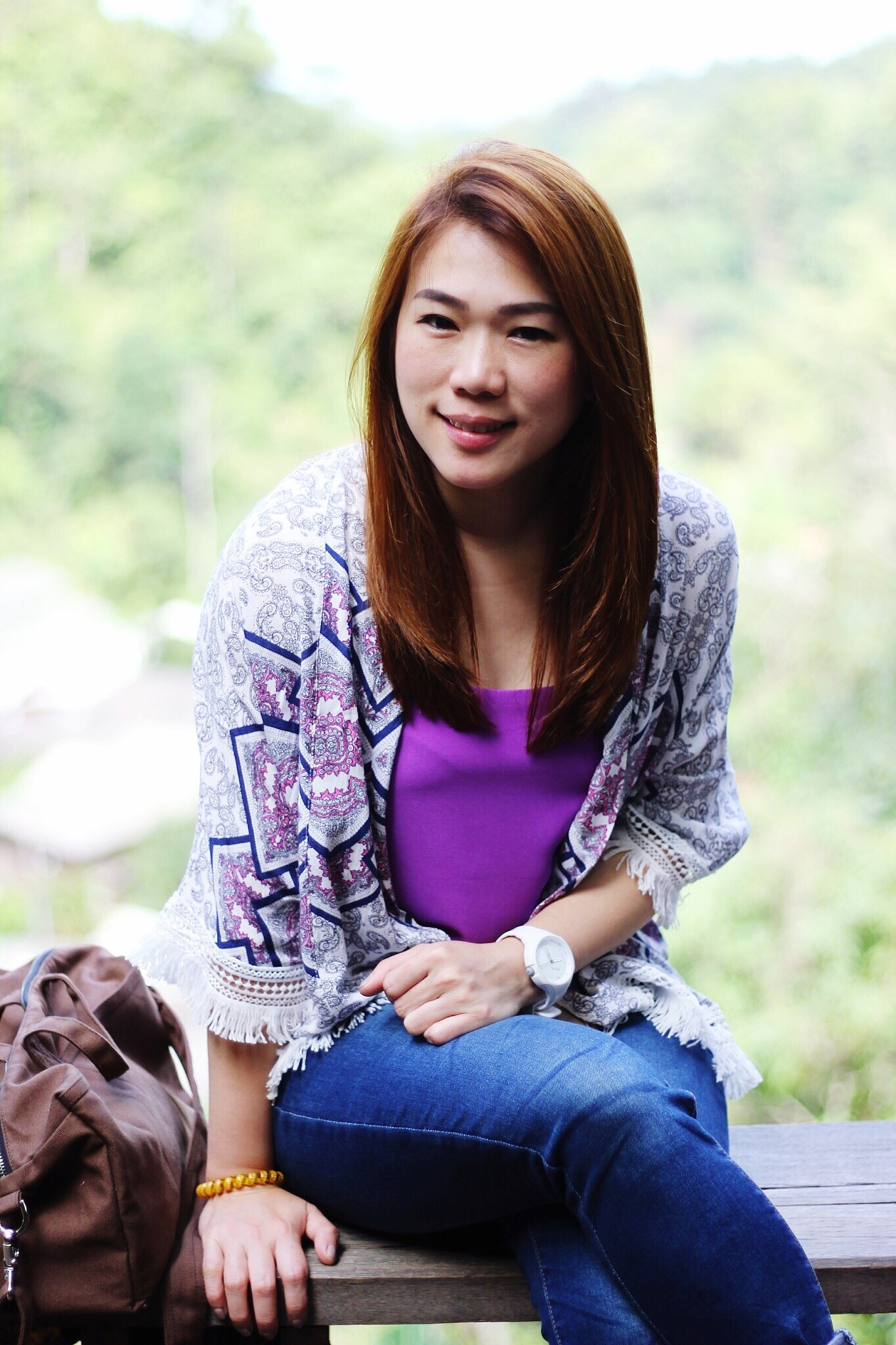 portrait of young woman sitting outdoors