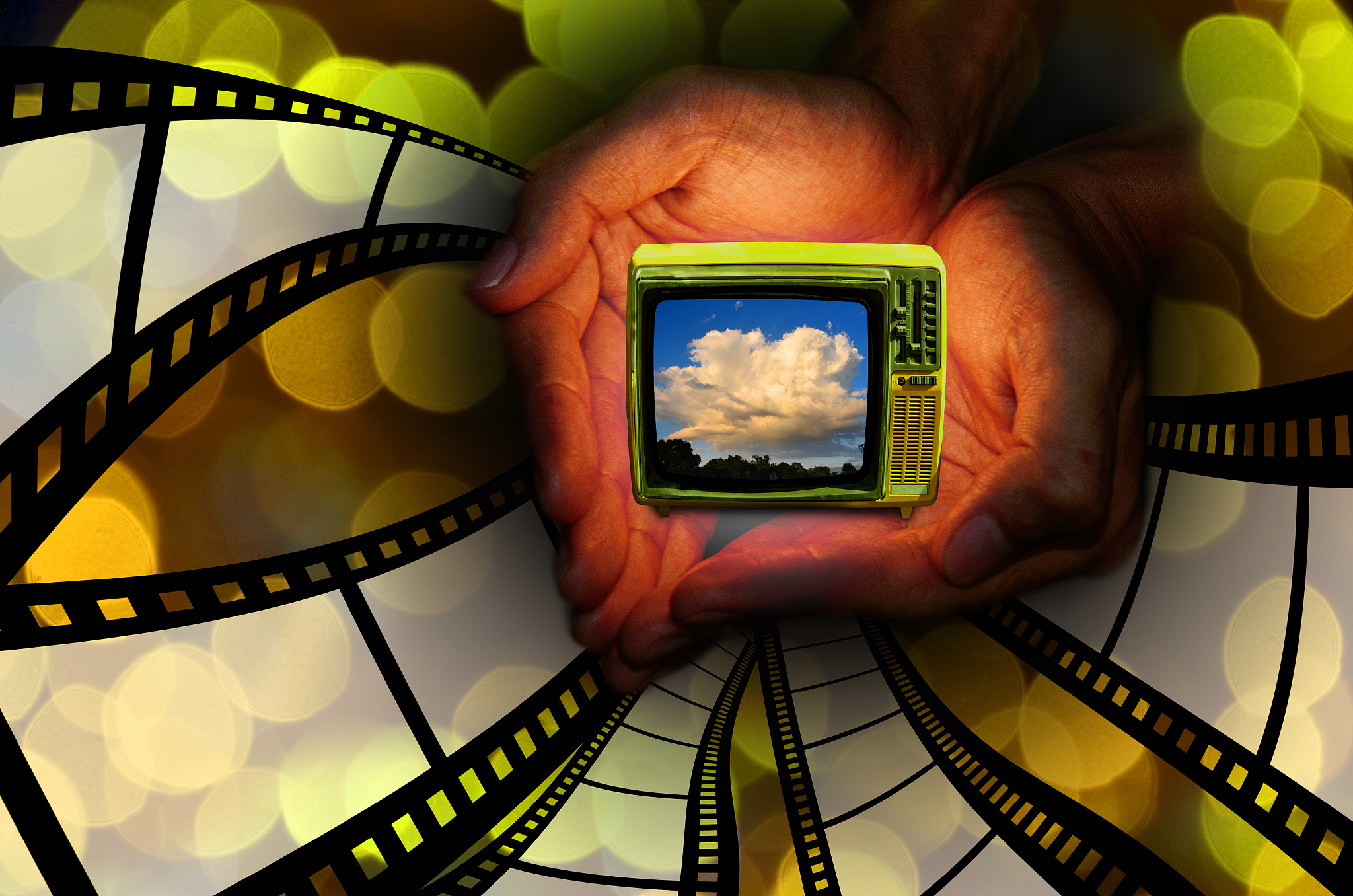 retro television in hand with flying filmstrip, entertainment in