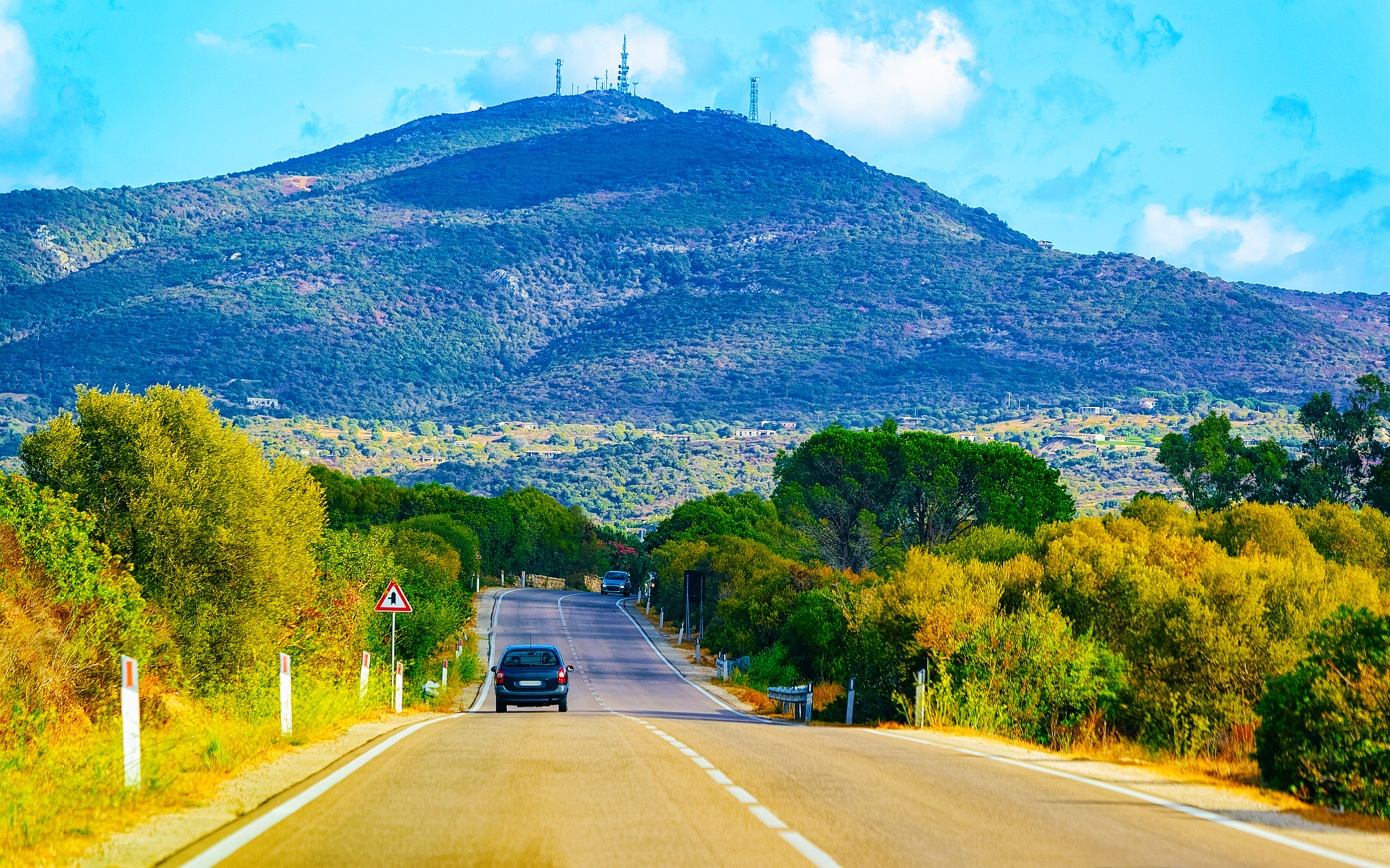 car on road in costa smeralda in sardinia island hills