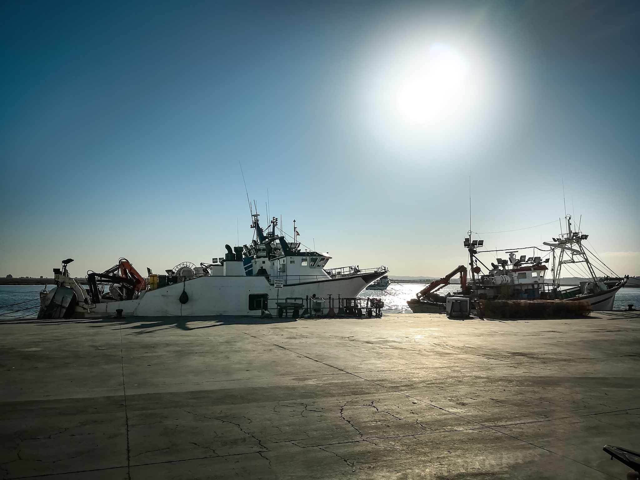 fishing boats in a spanish harbor. front view backlight maritime