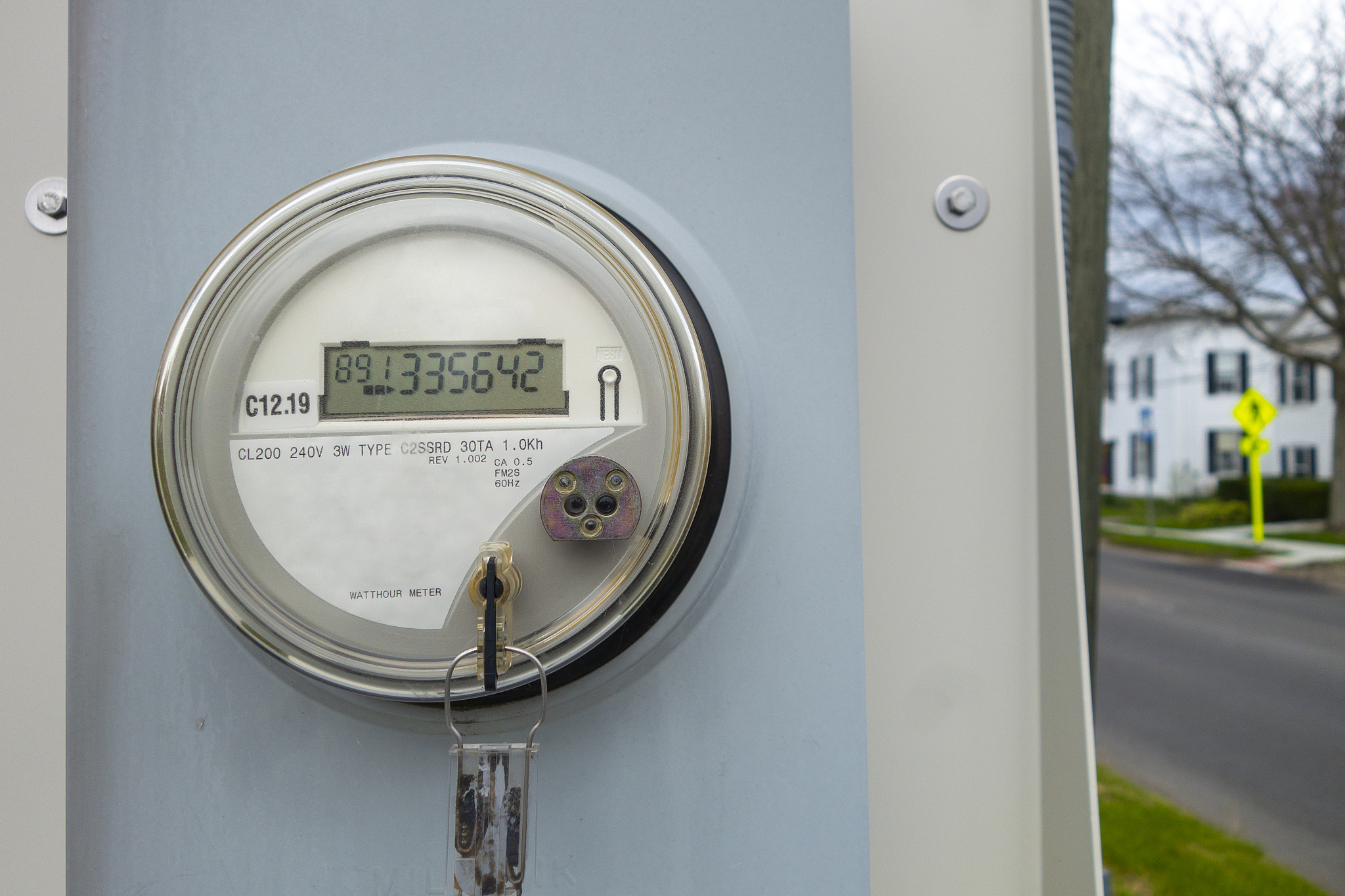 digital meter reading on a street walkway side box.