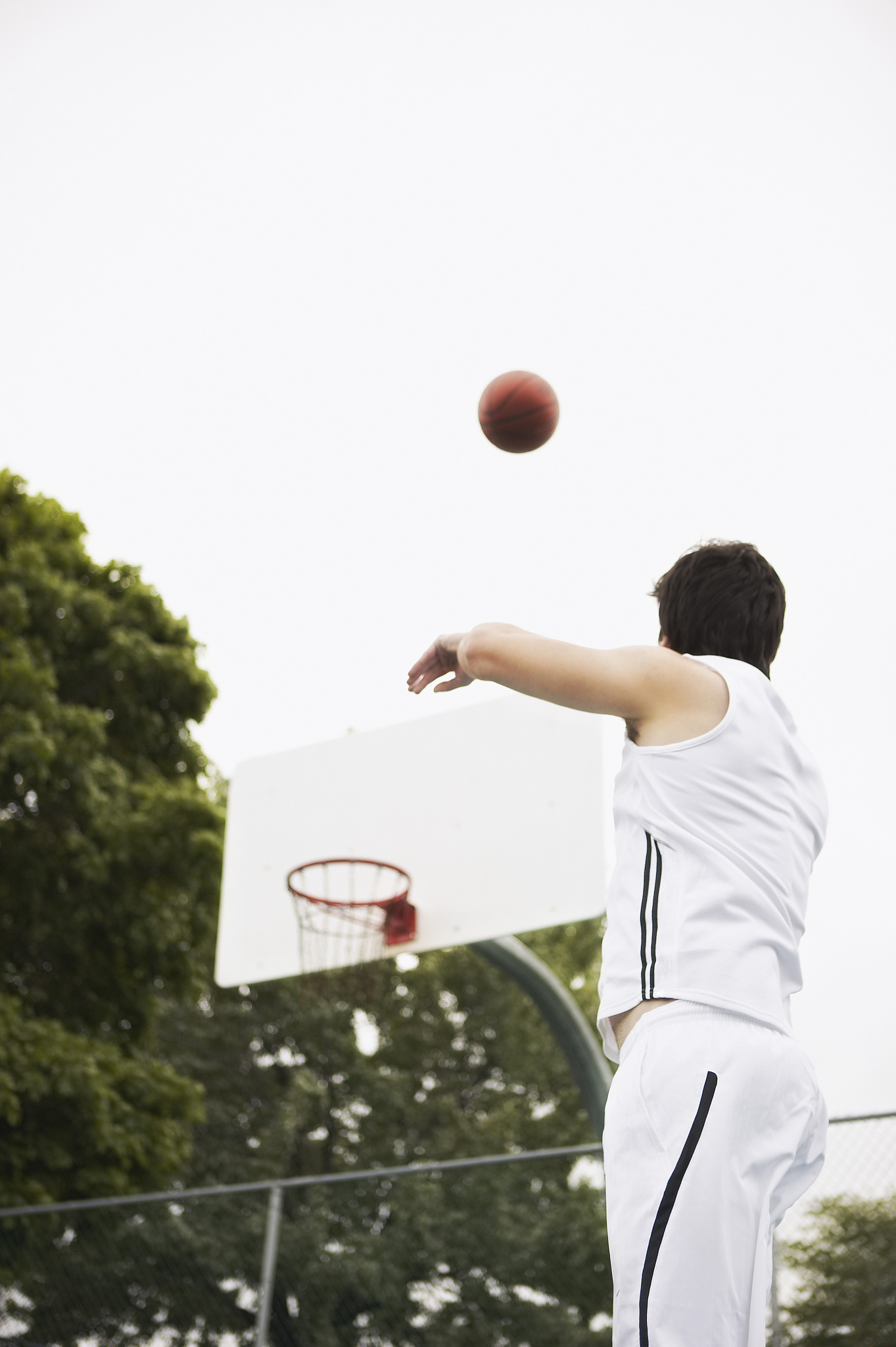 man shooting basketball