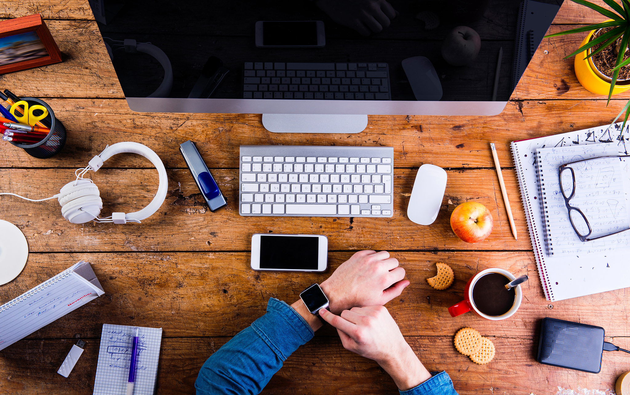 business person working at office desk wearing smart watch