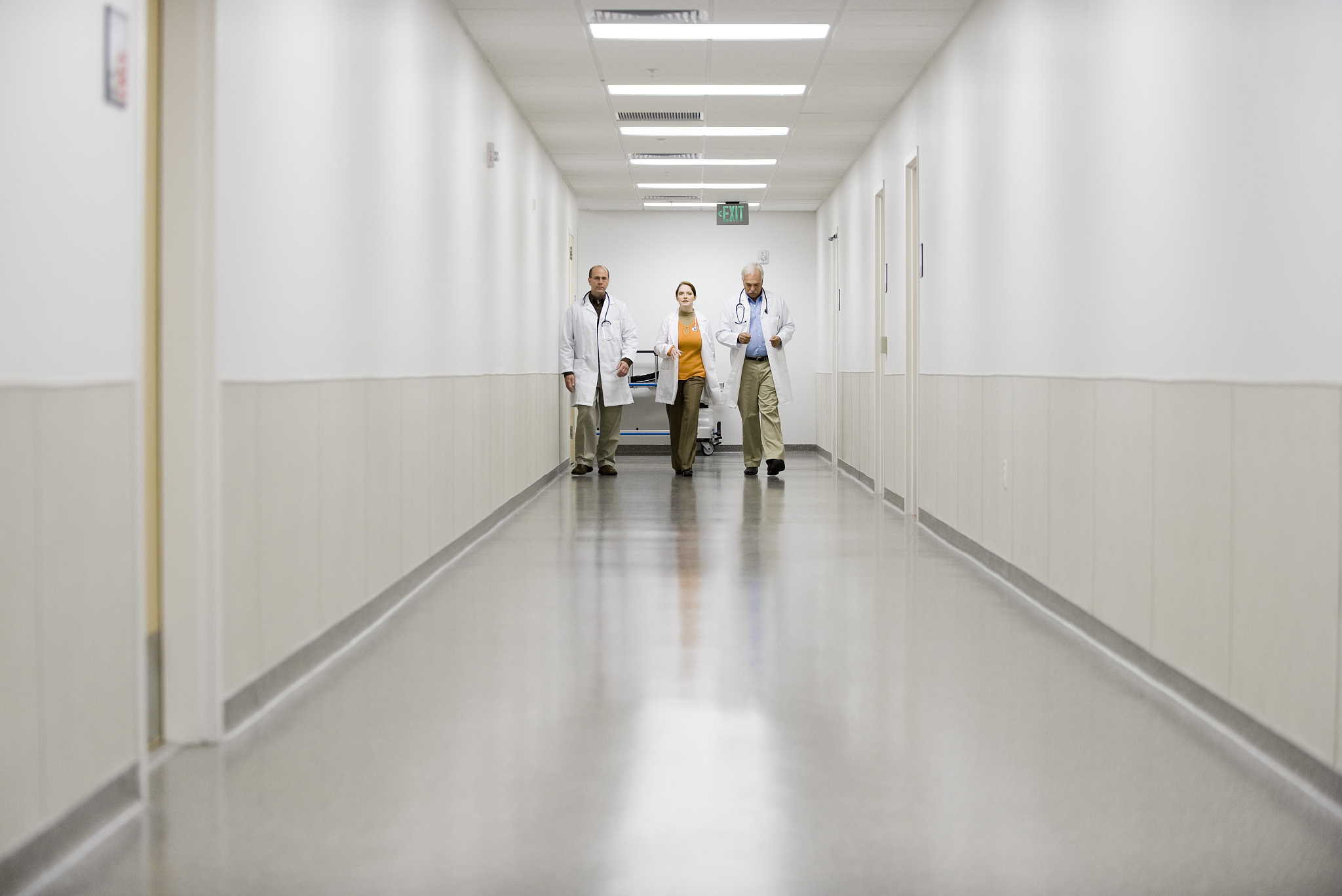 doctors hurrying down hospital corridor