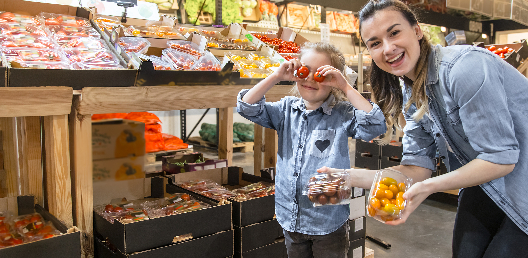 cheerful smiling young woman with little daughter buying globe t