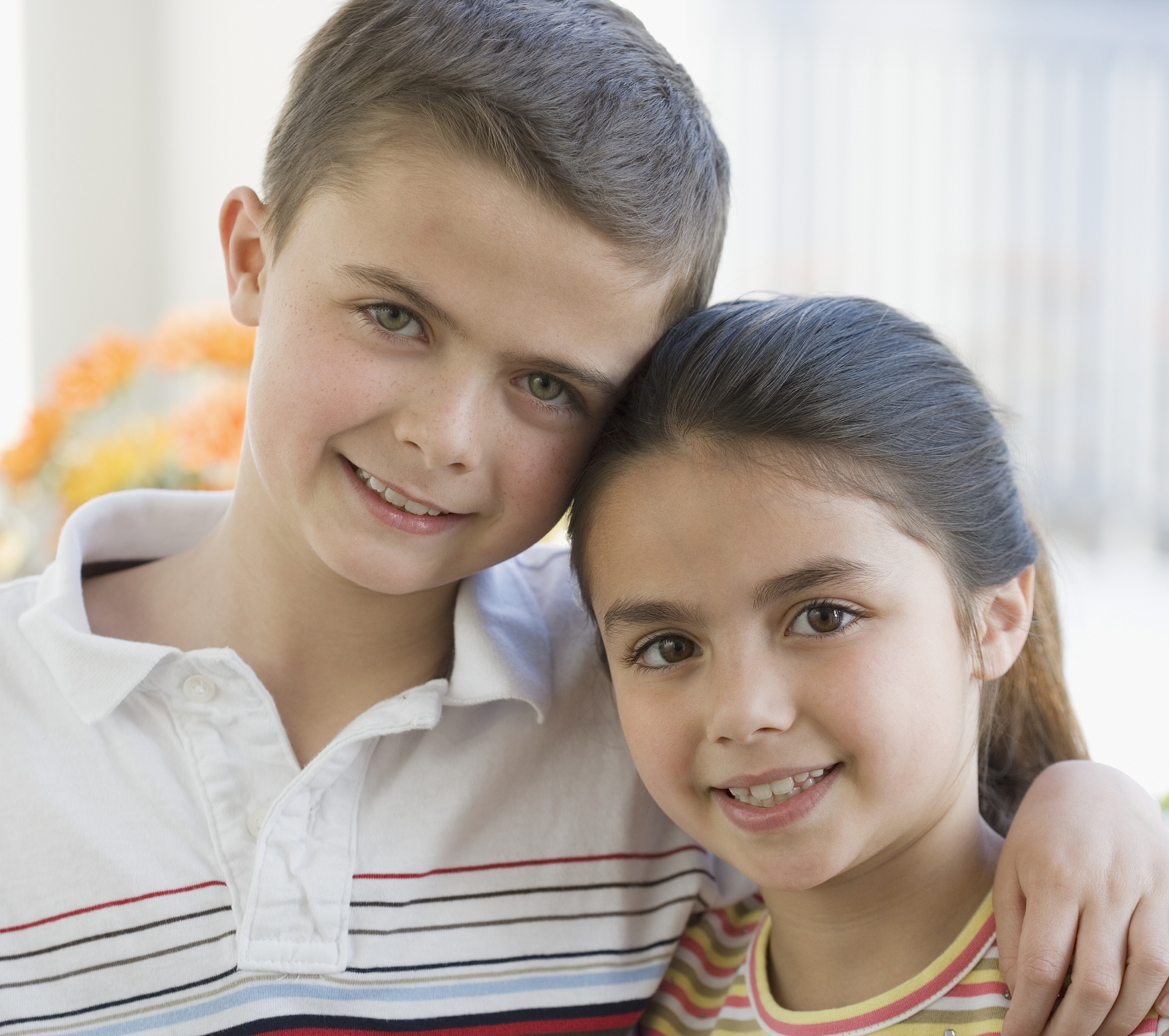 close up of brother and sister hugging