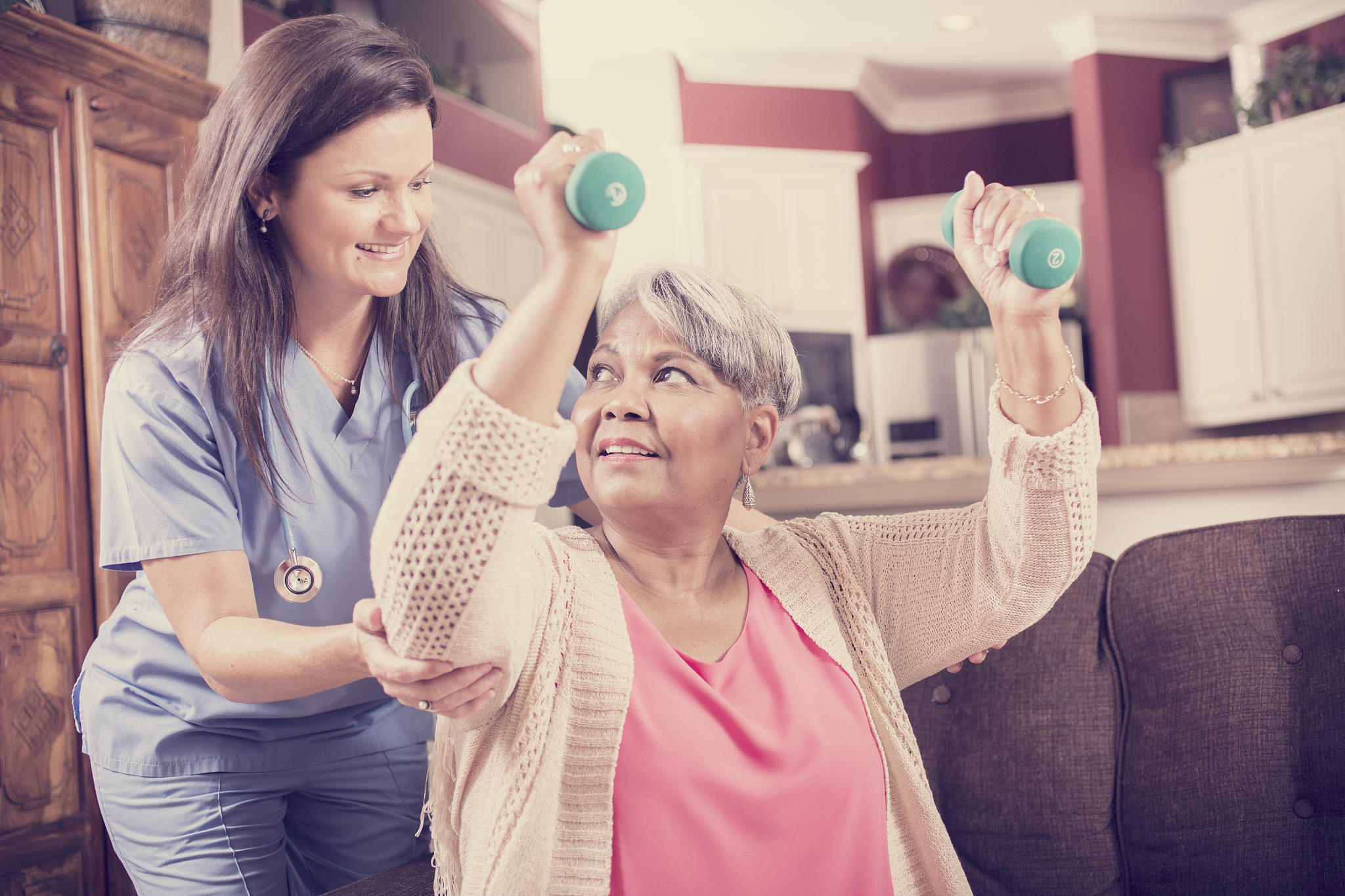 home healthcare nurse, physical therapy with senior adult woman.