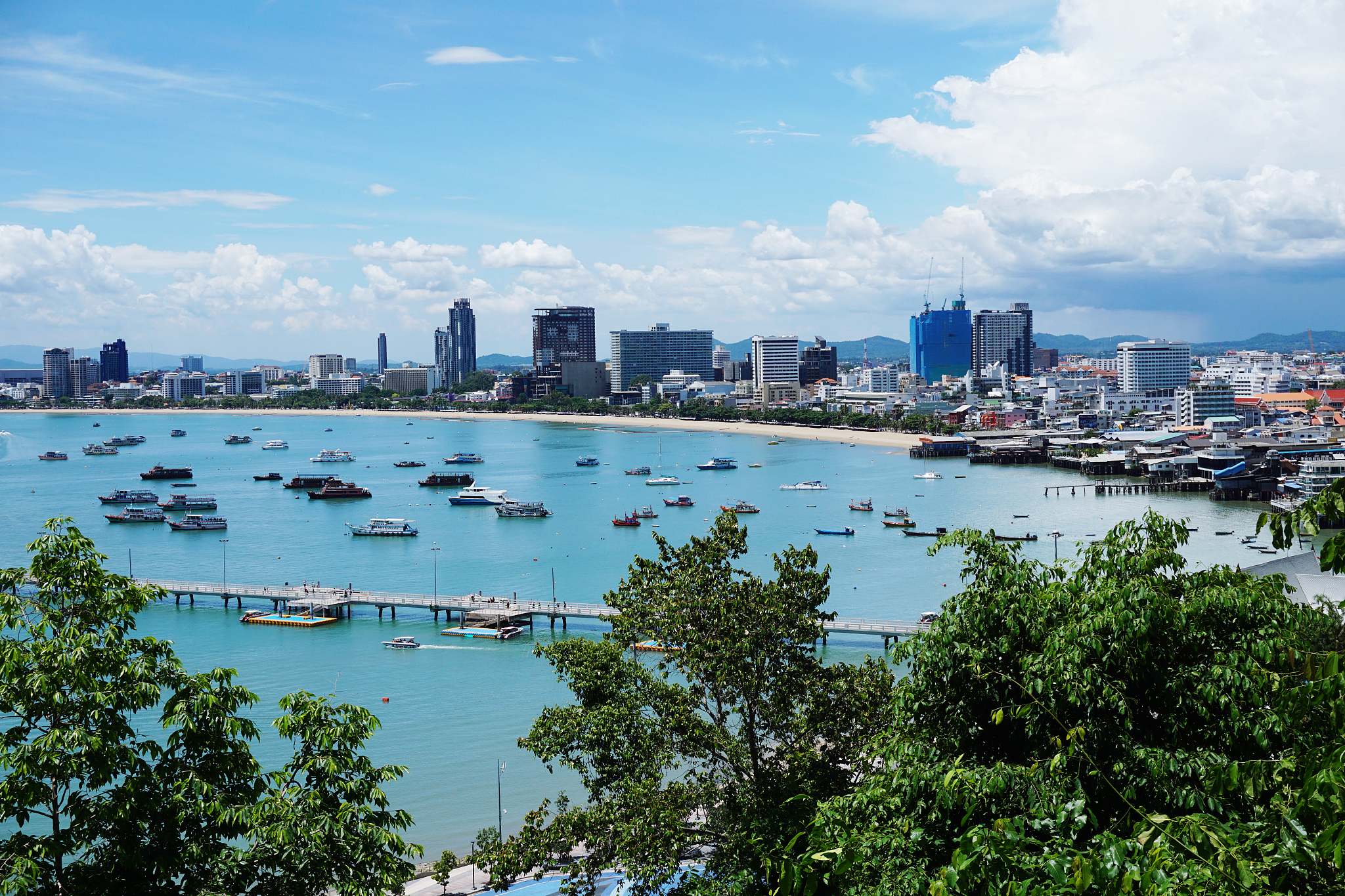 scenic view of sea and city buildings against sky