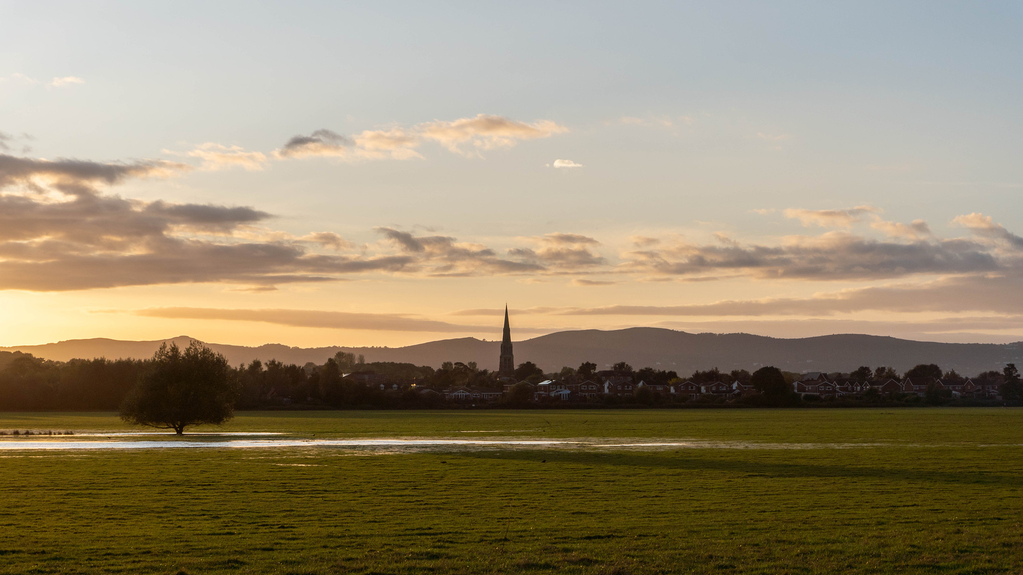 sunset across a flooded meadow, on a october evening. with a chu