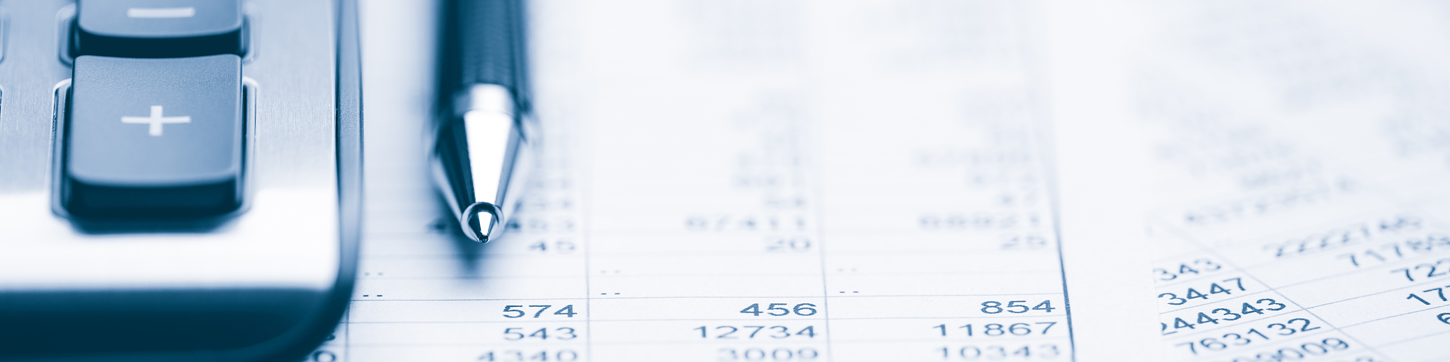 close-up of pen and calculator on financial report